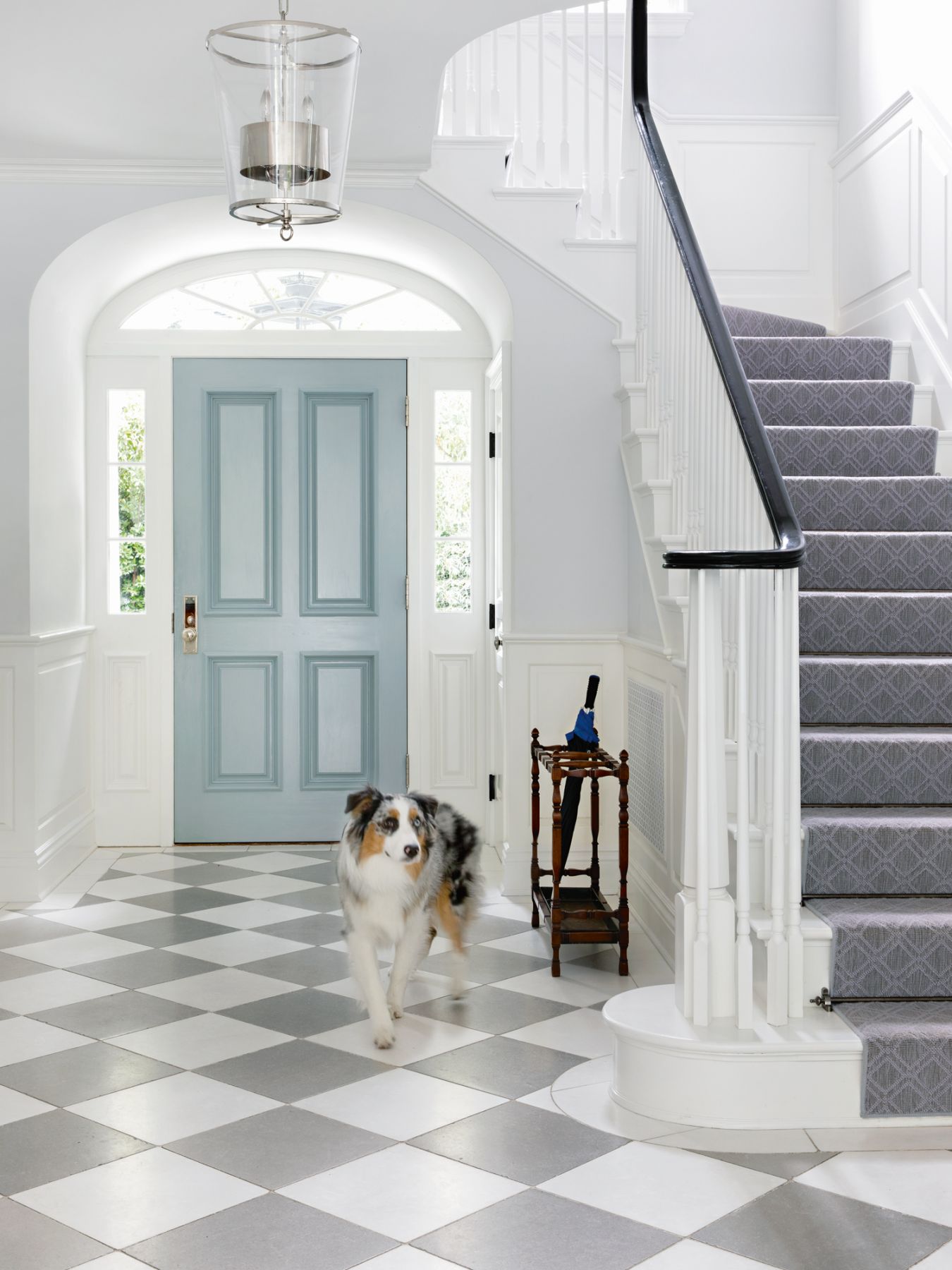 The checkerboard flooring adds visual interest to the entryway