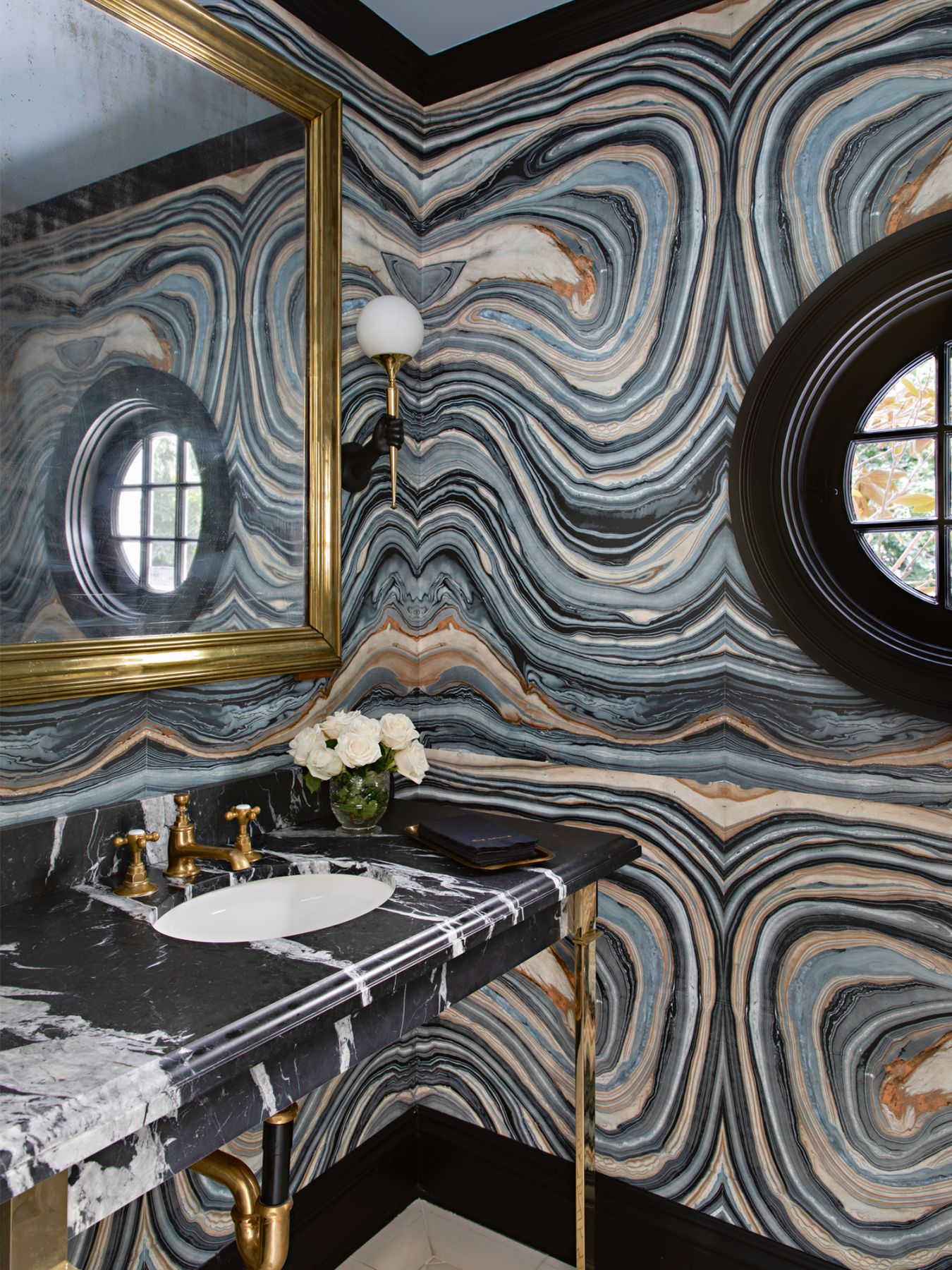 The graphic lines on the stone walls and countertop create an impact in this powder room