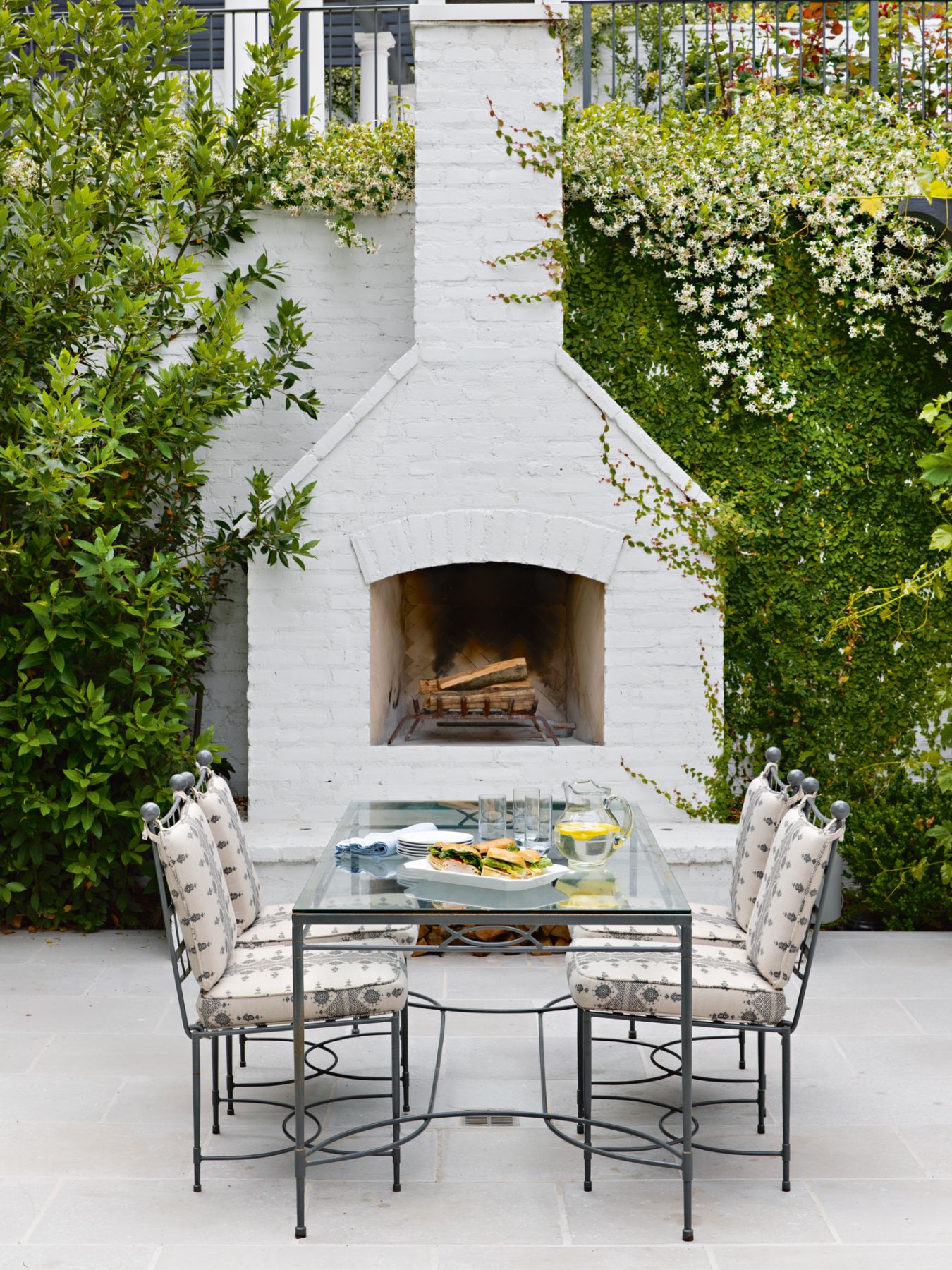 In the garden, outdoor dining furniture from Janus et Cie in Perennials fabrics provides a cosy spot for al fresco meals