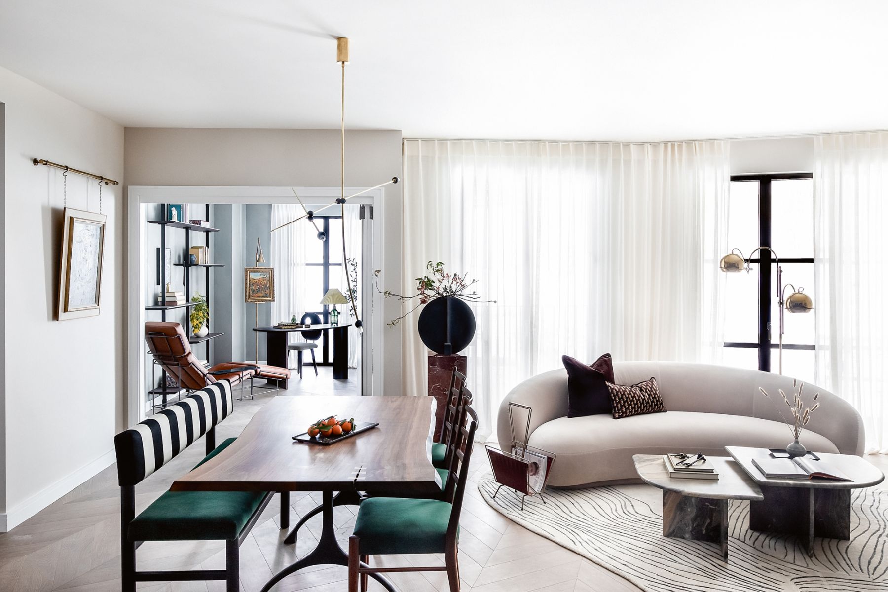 A lighting piece by Greek designer Periclis Frementitis floats above the dining table from British studio Martelo & Mo