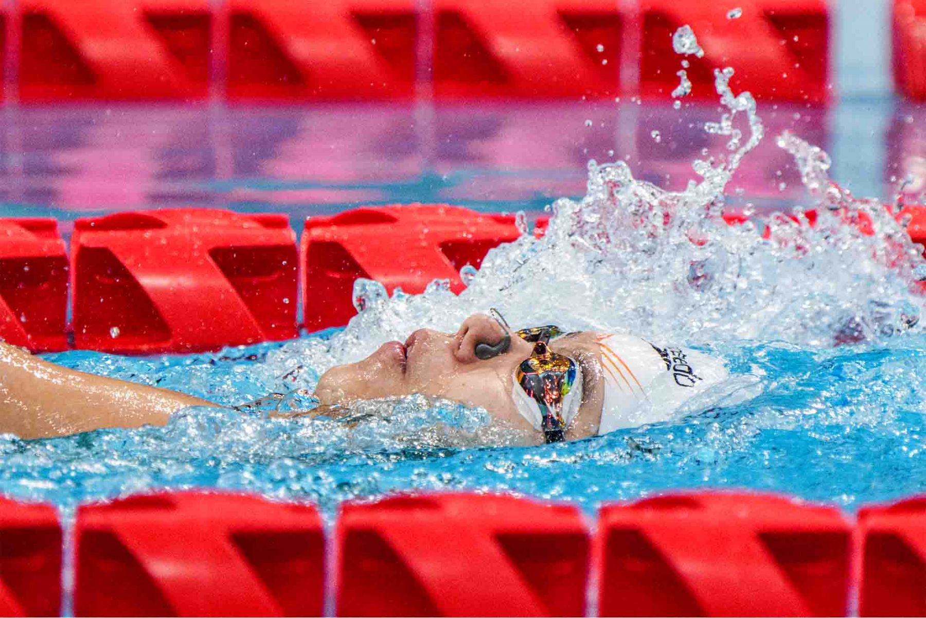 Singapore's Yip Pin Xiu competes in a heat of the women's 100m backstroke swimming event. (Photo: AFP and Sport Singapore)