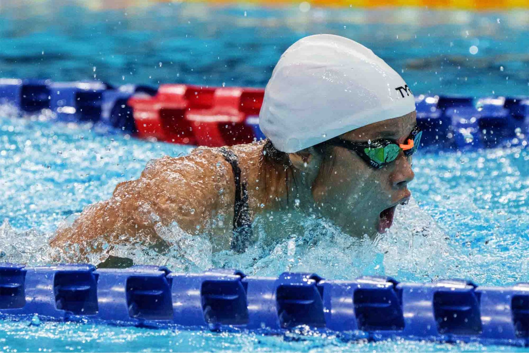 Singapore's Sophie Soon Jin Wen competes in a heat of the women's 100m backstroke swimming event. (Photo: AFP and Sport Singapore)