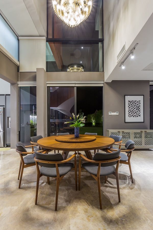 A modern metal chandelier adds grandeur but not ostentation to the dining room