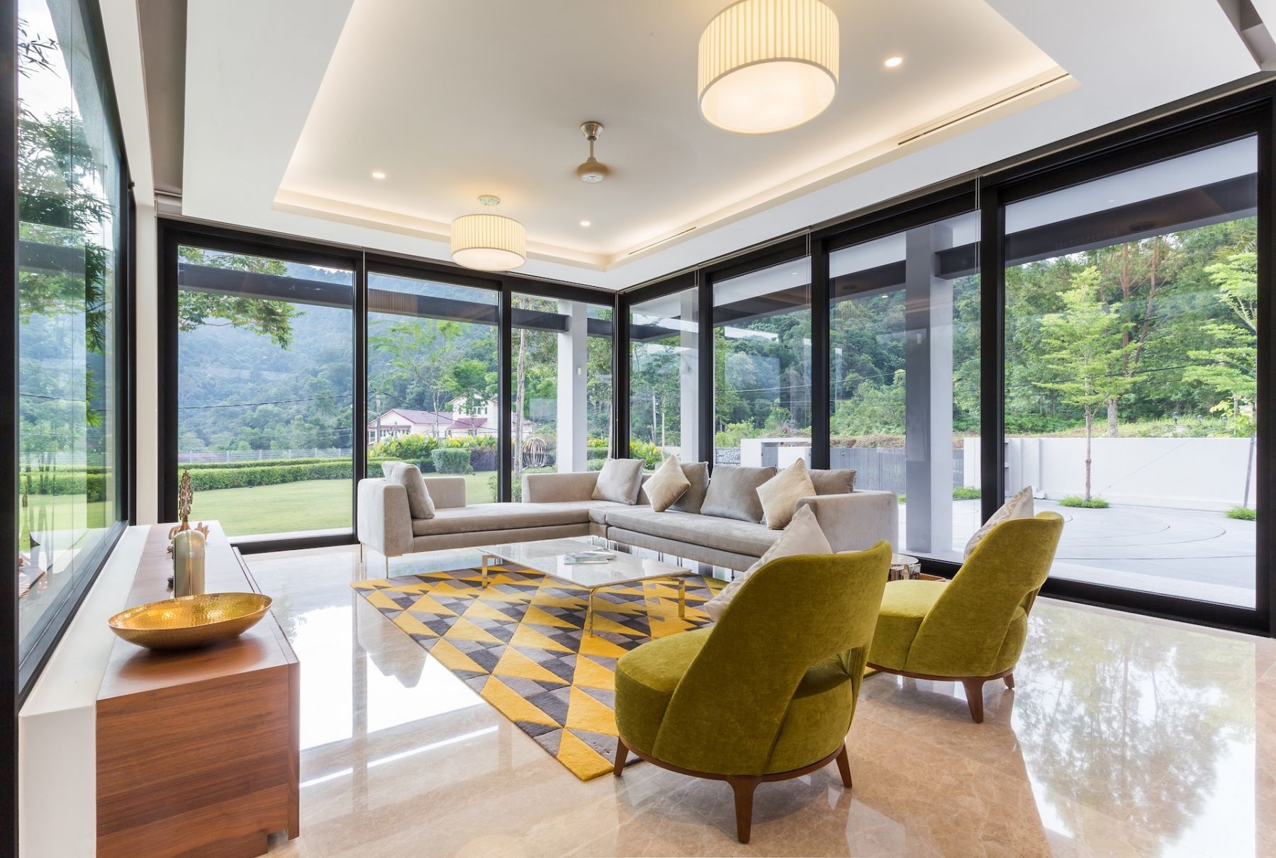 Mid-century style armchairs and a modern sofa look perfectly at home in the light-filled living room