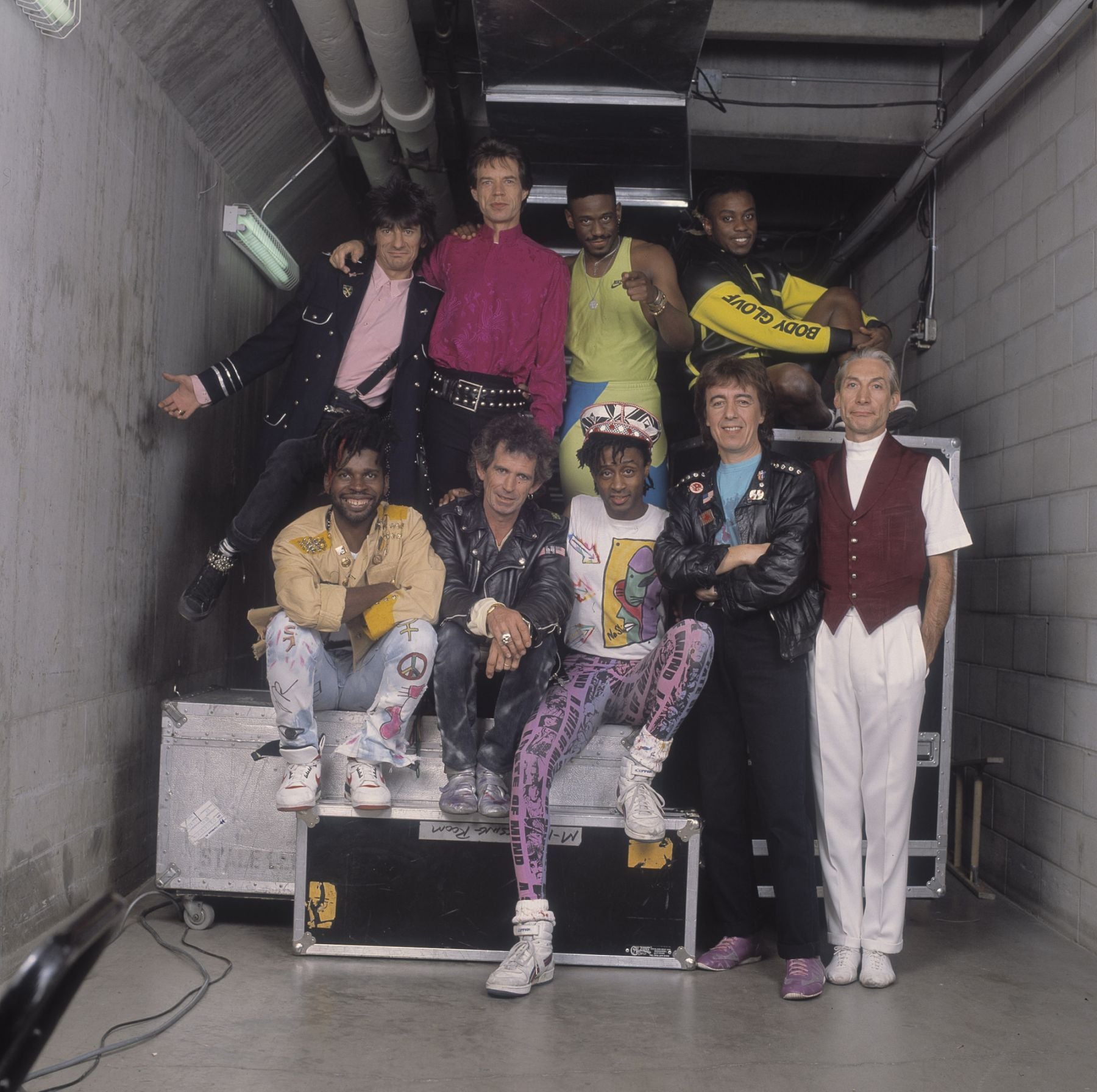 Backstage at the Rolling Stones' 'Steel Wheels' tour, the Rolling Stones poses with Living Colour, late 1989. Pictured are back row from left, Ron Wood, Mick Jagger, Will Calhoun, and Corey Glover; front row, from left, Vernon Reid, Keith Richards, Muzz Skillings, Bill Wyman, and Charlie Watts. (Photo by Paul Natkin/Getty Images)