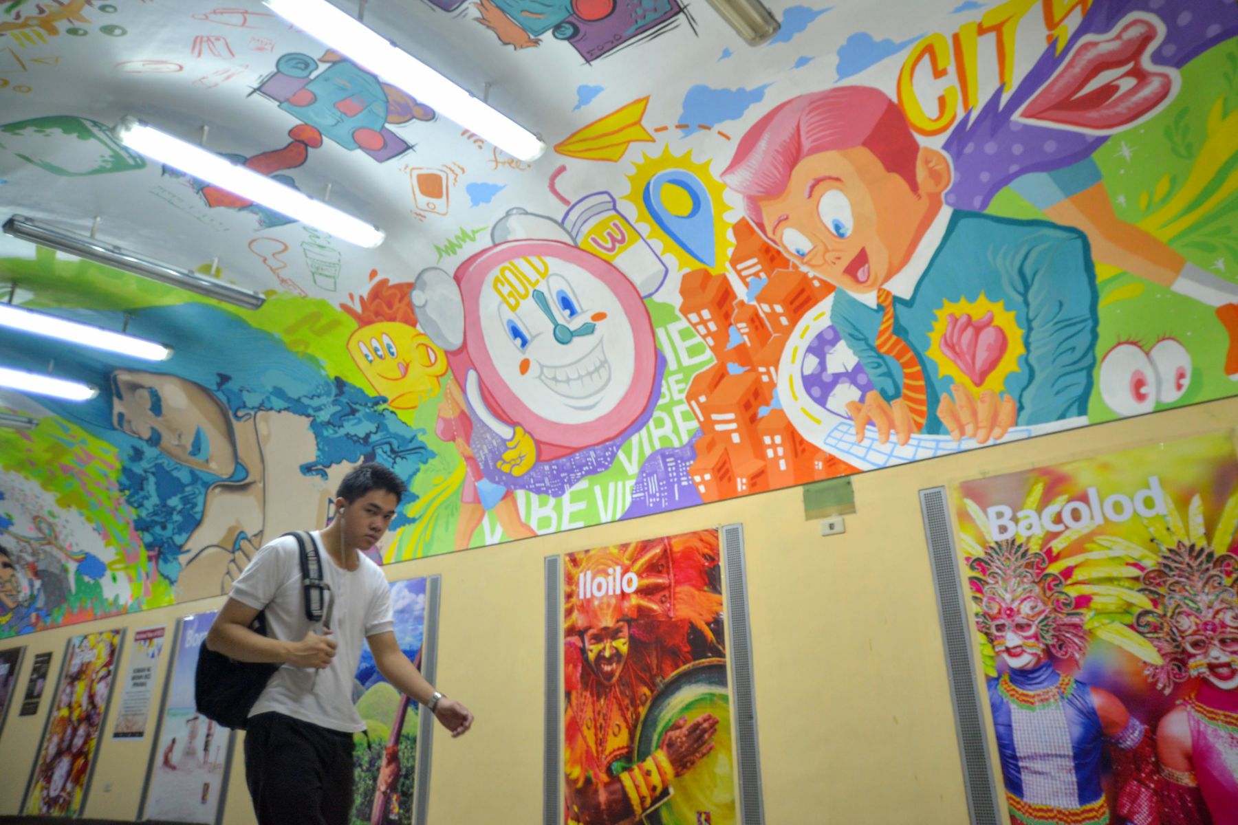 A man passes by a colourful mural painted along the ceiling of a pedestrian underpass in the financial district of Makati, Metro Manila, Philippines, June 3, 2014. Photo: Ezra Acayan/NurPhoto (Photo by NurPhoto/Corbis via Getty Images)