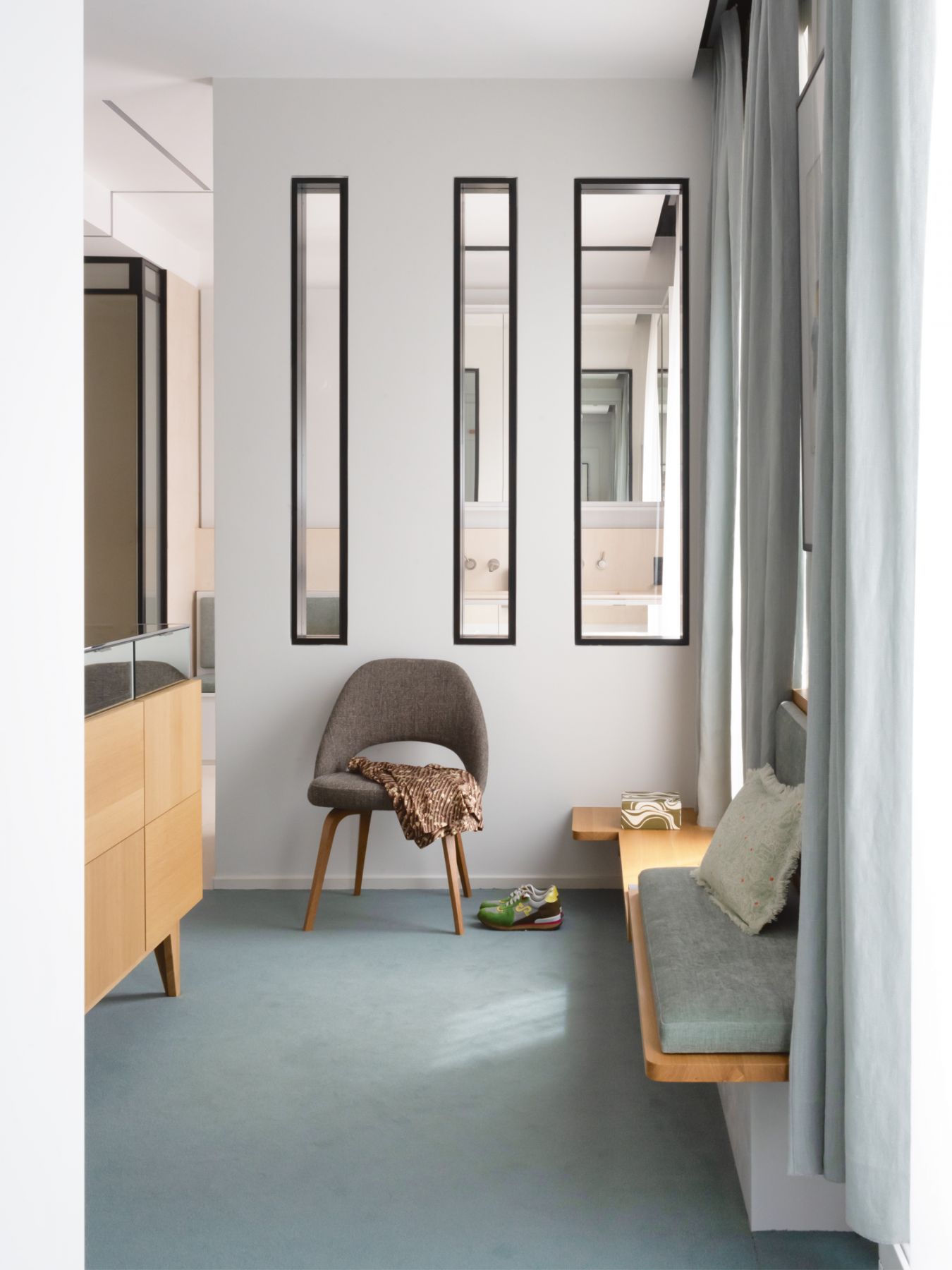 The rectangular cut-outs lend a playful touch to a corner of the walk-in wardrobe