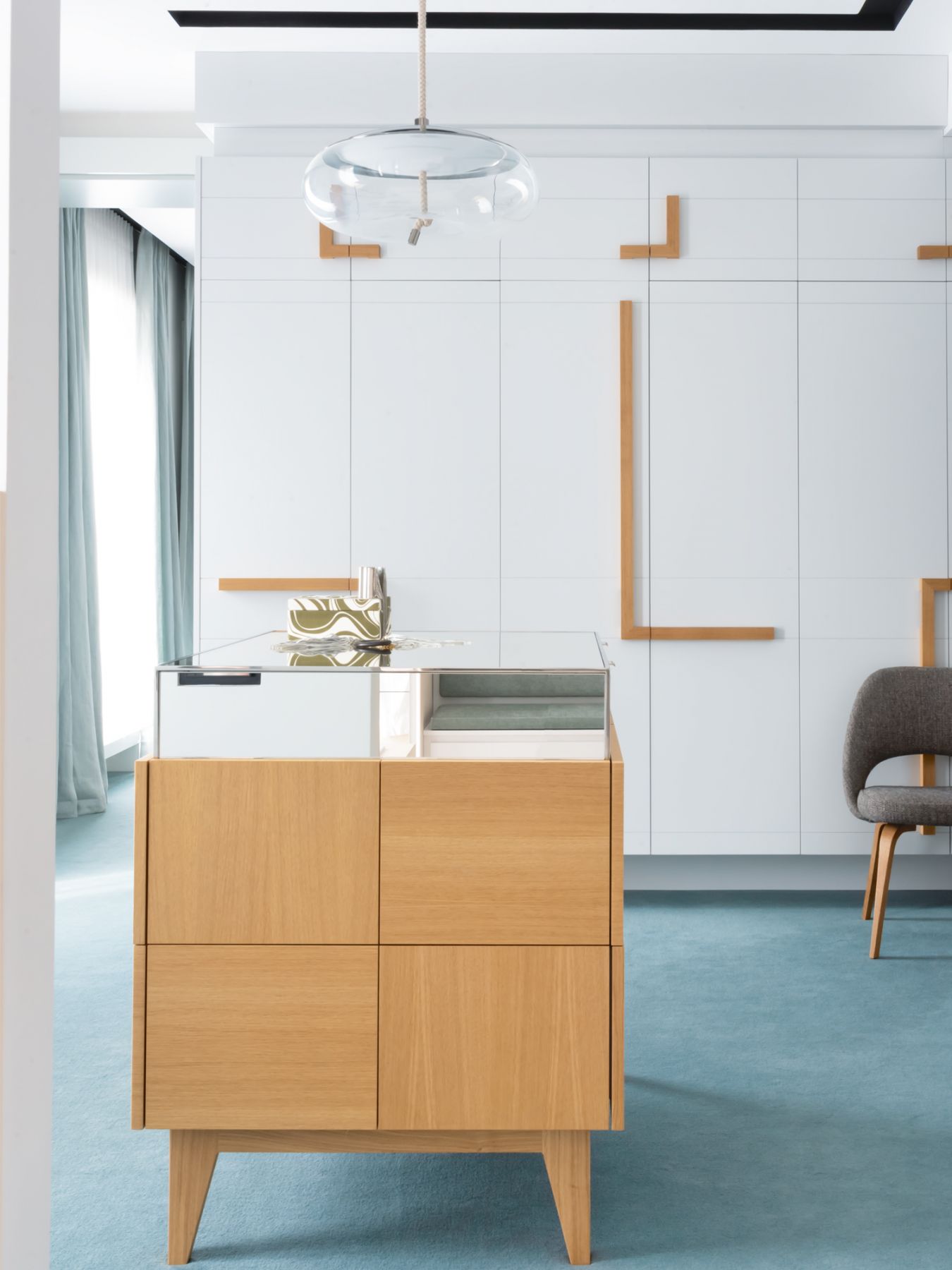 Geometric detailing on the cabinetry adds visual interest to the wardrobe area