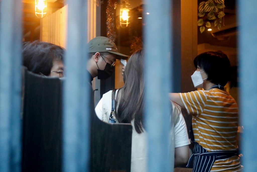 Restaurant worker takes temperature for customers following 206 new domestic Covid cases reported Sunday, a record high since the pandemic started to expand, in Taipei, Taiwan, 16 May 2021. Stricter restrictions including compulsory mask wearing in public areas and limiting large gatherings have been imposed in the capital Taipei and new Taipei. (Photo by Ceng Shou Yi/NurPhoto via Getty Images)