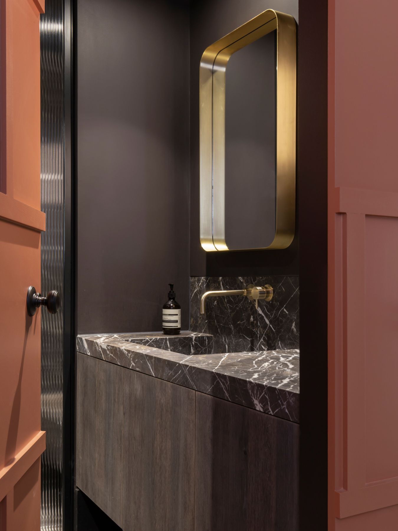 The guest bathroom is a grand space designed with black marble
