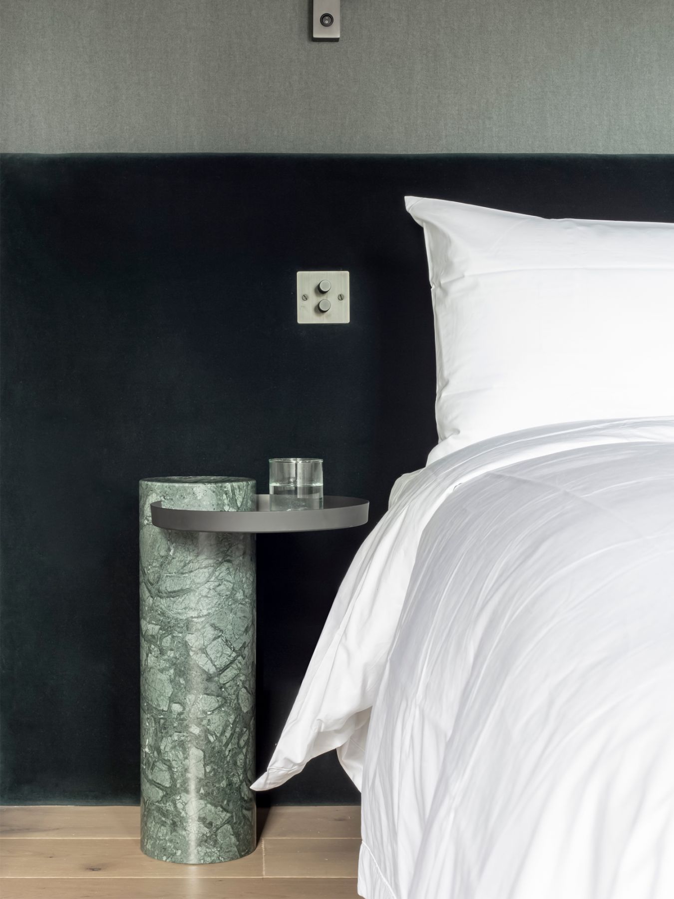 The La Chance Salute side tables, designed by Sebastian Herkner, feature a green marble base and a black tray top