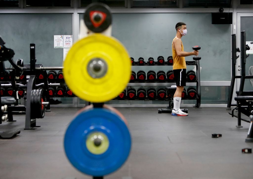 A male with a face mask is doing workout at a gym, as the nationwide Covid-19 alert has been lowered to Level 2 following a month of combating a local outbreak, in Taoyuan, Taiwan, 28 July 2021. Non essential businesses including Cinemas, restaurants and sports facilities have been allowed to take customers under the lowered alert, but several cities including Taipei refused to follow the implementation by Taiwans CDC in fear of uncurbed transmissions, while the country is boosting its immunity rate with A