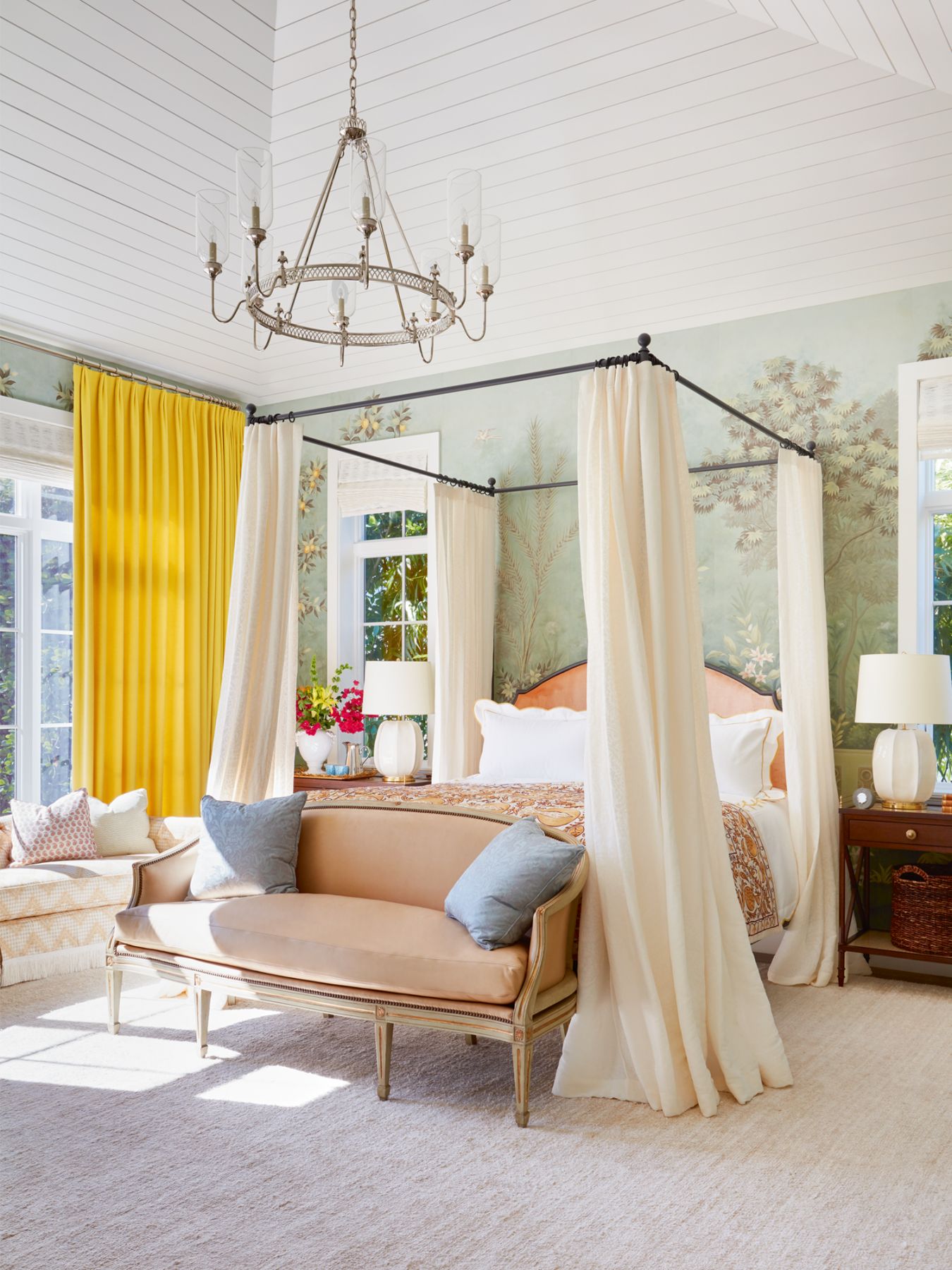 The peach headboard and yellow curtains brighten up the serene and elegant master bedroom