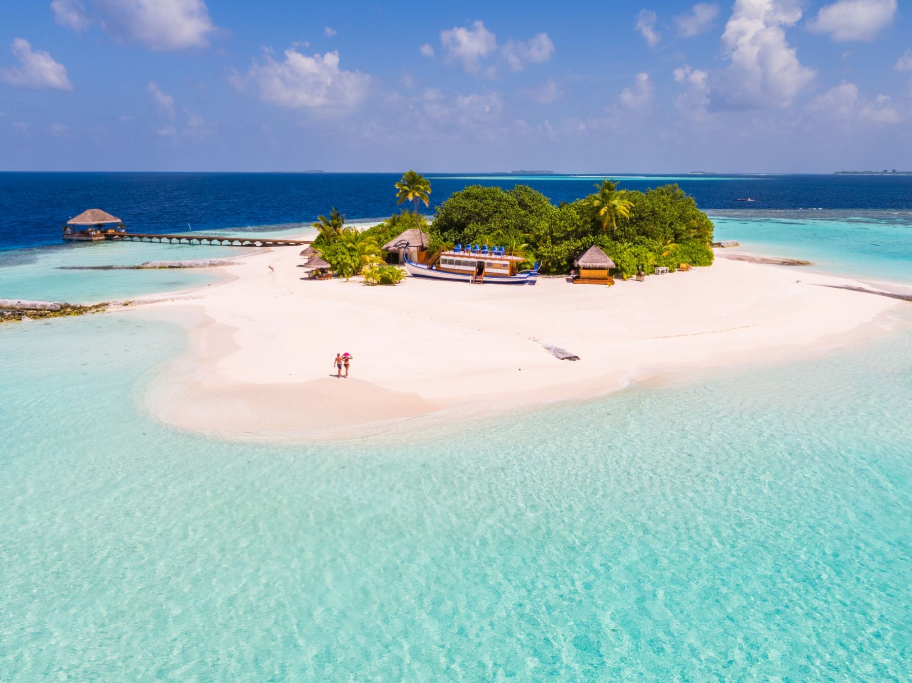 Aerial drone view of adult couple on a sandy beach, Maldives (MR)