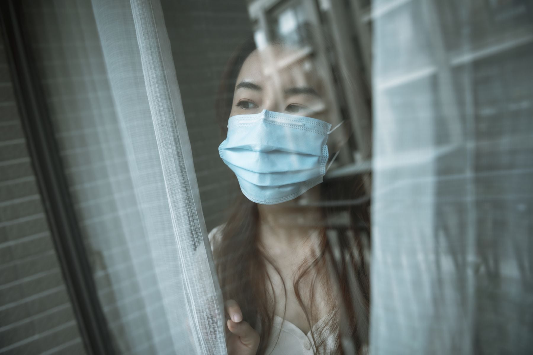 Woman wearing mask at home during isolation