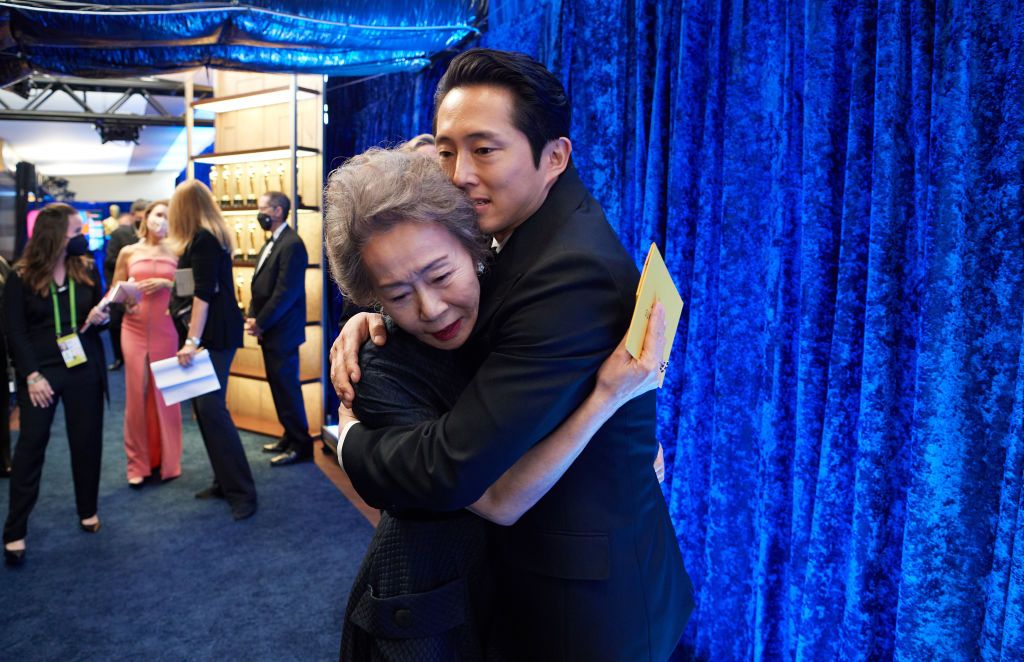 LOS ANGELES, CALIFORNIA â APRIL 25: (EDITORIAL USE ONLY) In this handout photo provided by A.M.P.A.S., Yuh-Jung Youn poses backstage with the Oscar® for Actress in a Supporting Role with Nominee Steven Yeun during the 93rd Annual Academy Awards at Union Station on April 25, 2021 in Los Angeles, California. (Photo by Richard Harbaugh/A.M.P.A.S. via Getty Images)