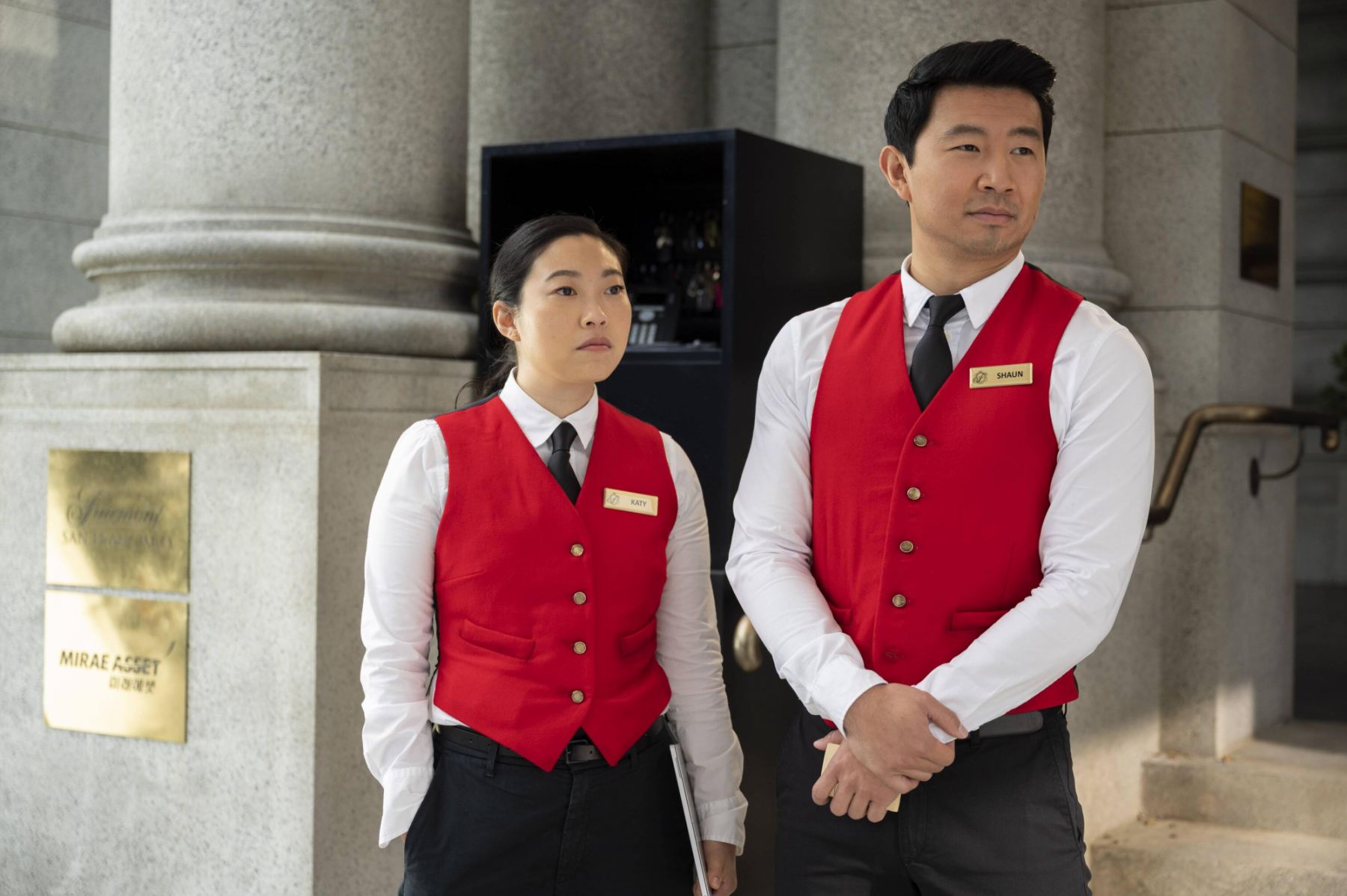 (L-R): Katy (Awkwafina) and Shang-Chi (Simu Liu) in Marvel Studios' SHANG-CHI AND THE LEGEND OF THE TEN RINGS. Photo by Jasin Boland. ©Marvel Studios 2021. All Rights Reserved.