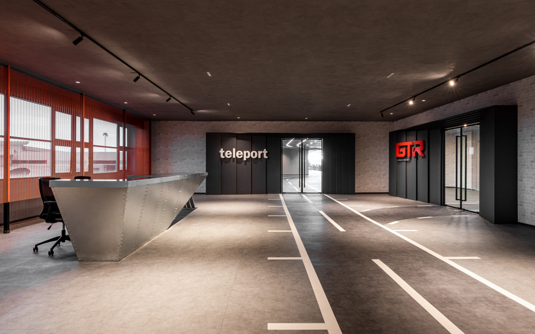 The reception desk has a view of planes landing and taking off behind it