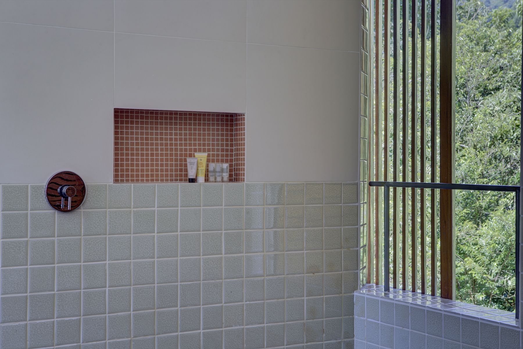 Bathrooms have large windows so indoors and outdoors seem seamless.