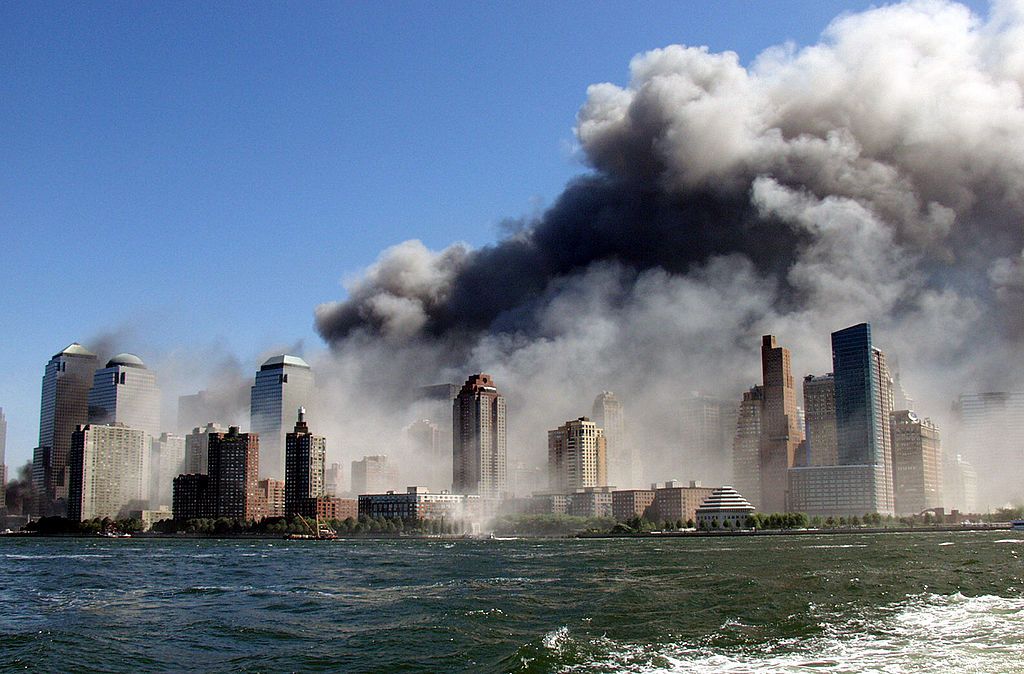 Smoke rises over the New York Skyline from the  scene of the World Trade Center Attack, as seen from a tugboat evacuating people from Manhattan to New Jersey. (Photo by Hiro Oshima/WireImage)