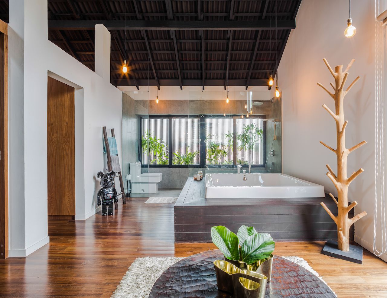 The master bath complete with a Jacuzzi in the centre, dressing counter and a corner walk-in wardrobe is a sanctuary for the couple