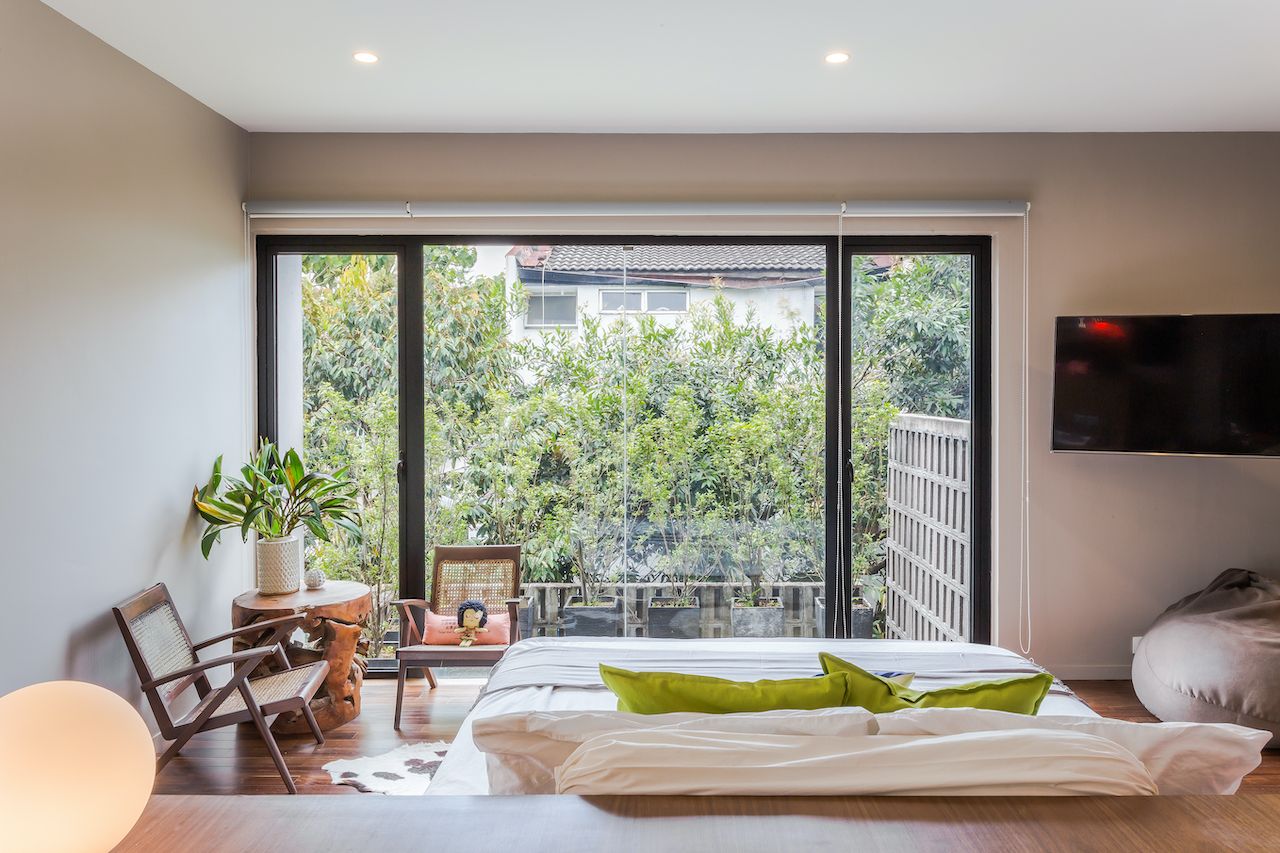 The master bedroom has a full view of the outdoor open sky terrace although planters and cement vent blocks provide privacy;