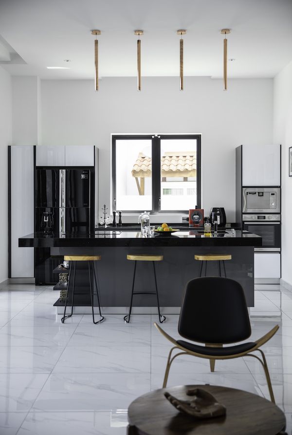 The open plan is minimal and elegant in black, white and hints of light coloured wood