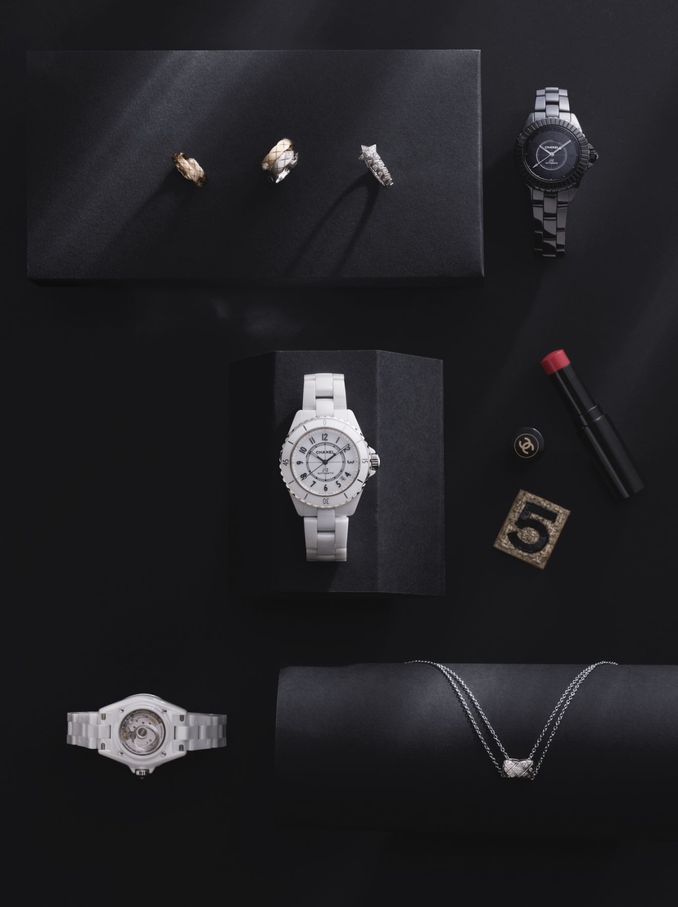 Clockwise, from top left: Coco Crush Toi et Moi ring (small) in beige gold set with diamonds, Coco Crush Toi et Moi ring (large) in beige and white gold set with diamonds, Com te Chevron ring in white gold set with diamonds, J12 calibre 12.2 Edition 1 33 mm watch, J12 calibre 12.1 38 mm watch, Coco Crush necklace in white gold set with diamonds, J12 calibre 12.2 Edition 1 33 mm watch