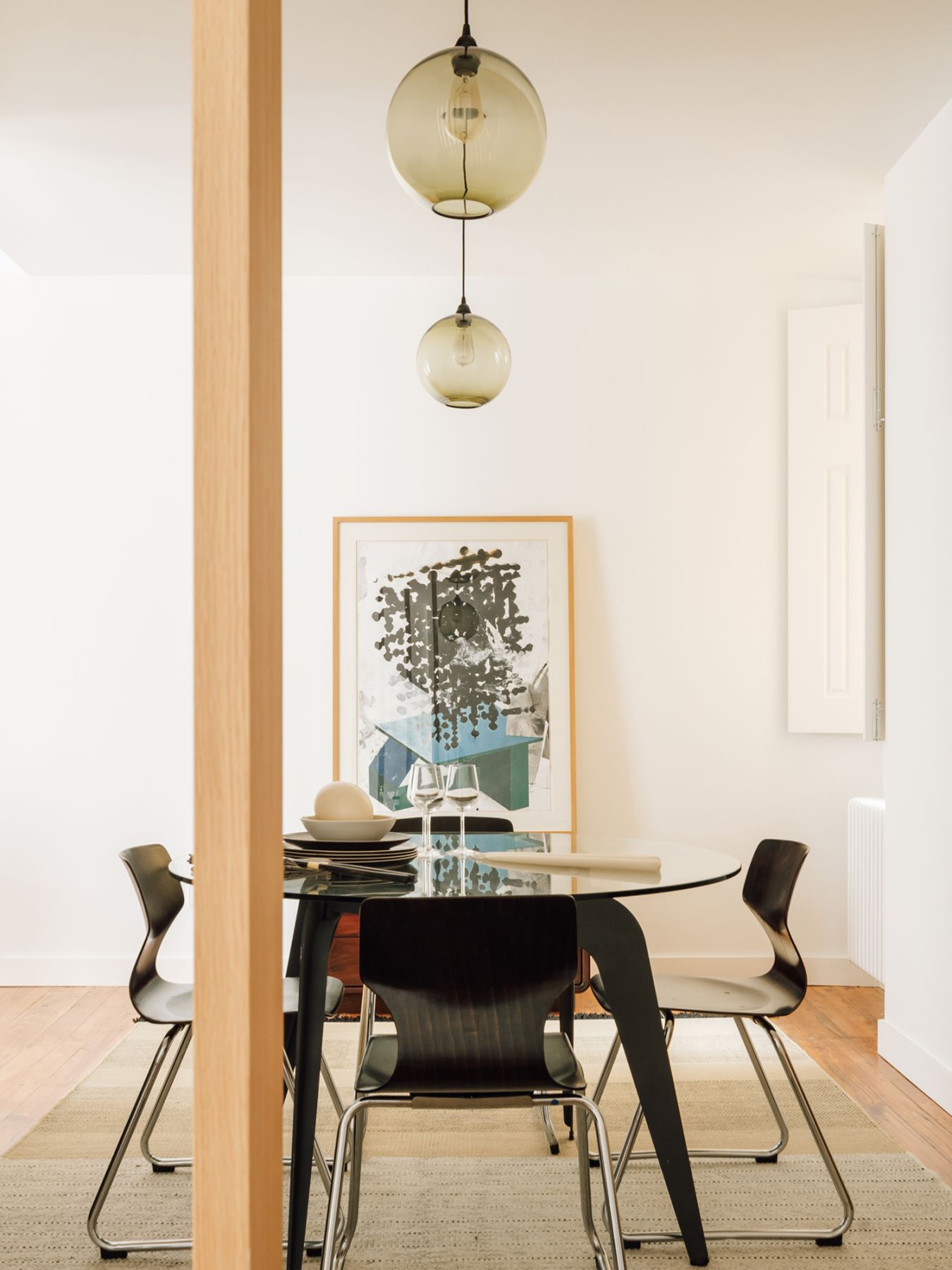 The wooden slats offer a peek into the dining room from the kitchen