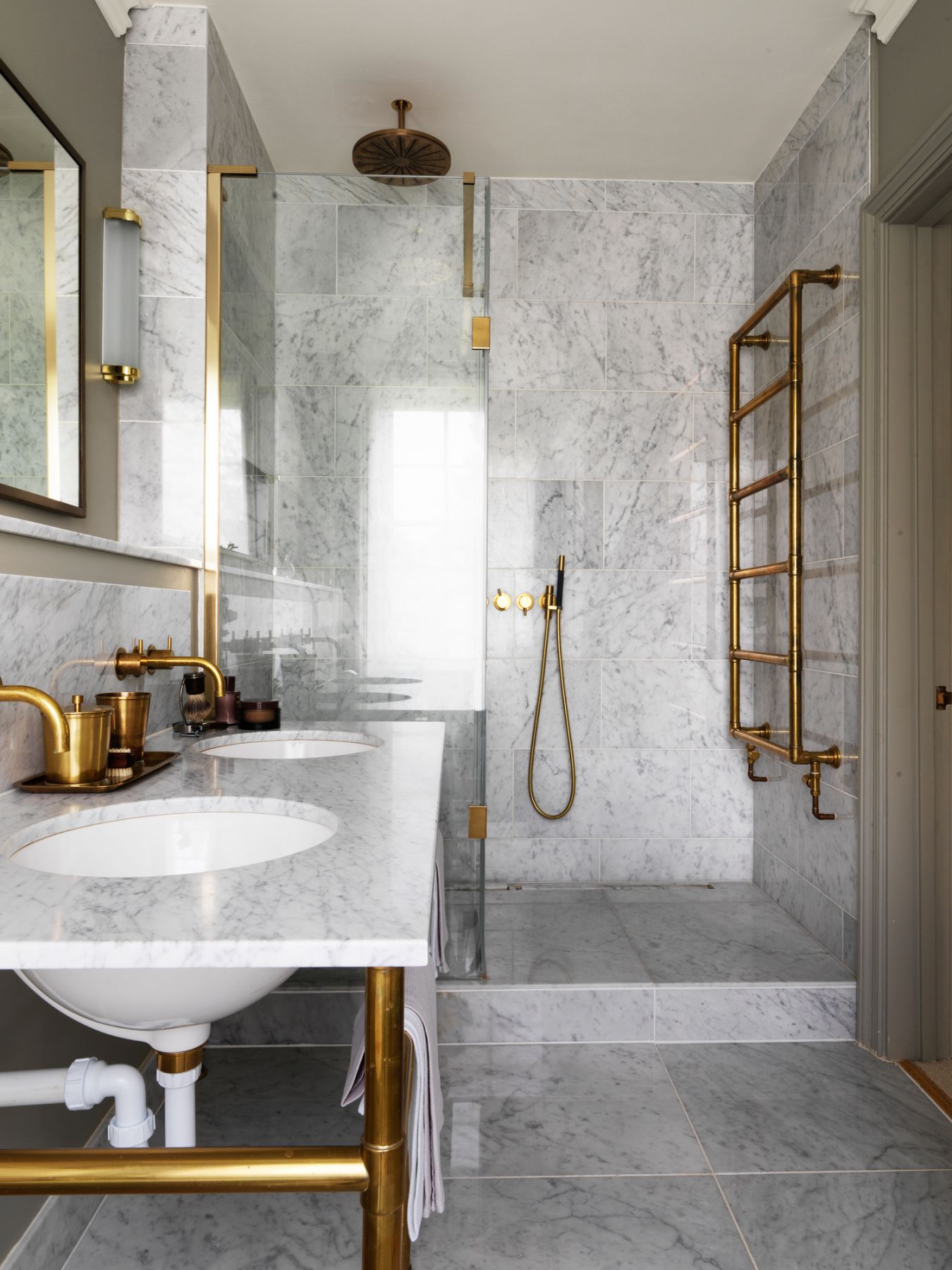 The elegant marble bathroom plays a modern contrast compared to the rustic Georgian home