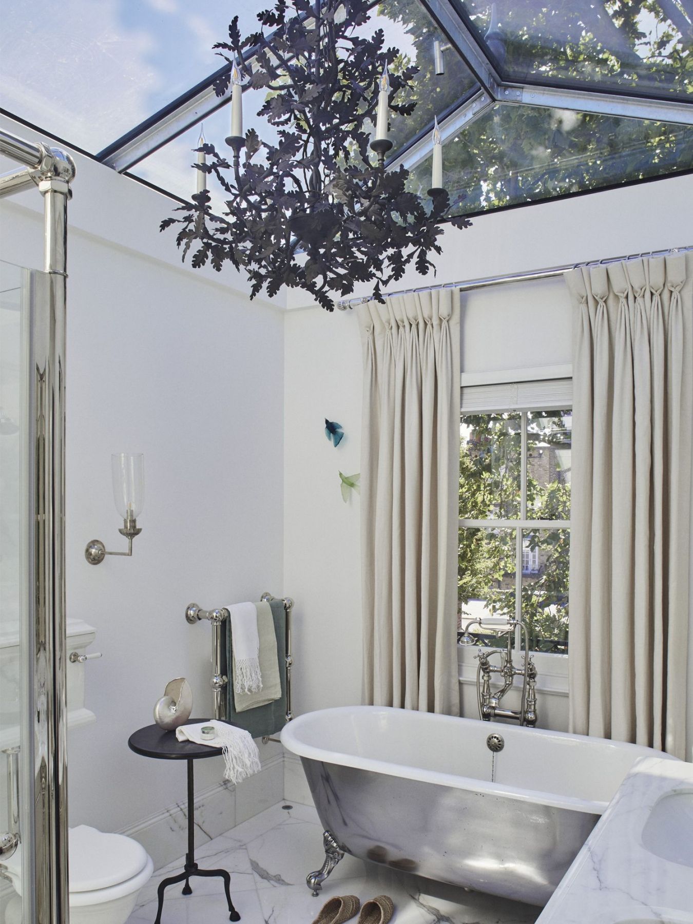 The master bathroom of this Georgian villa features a glass roof lantern that makes for a stunning architectural feature