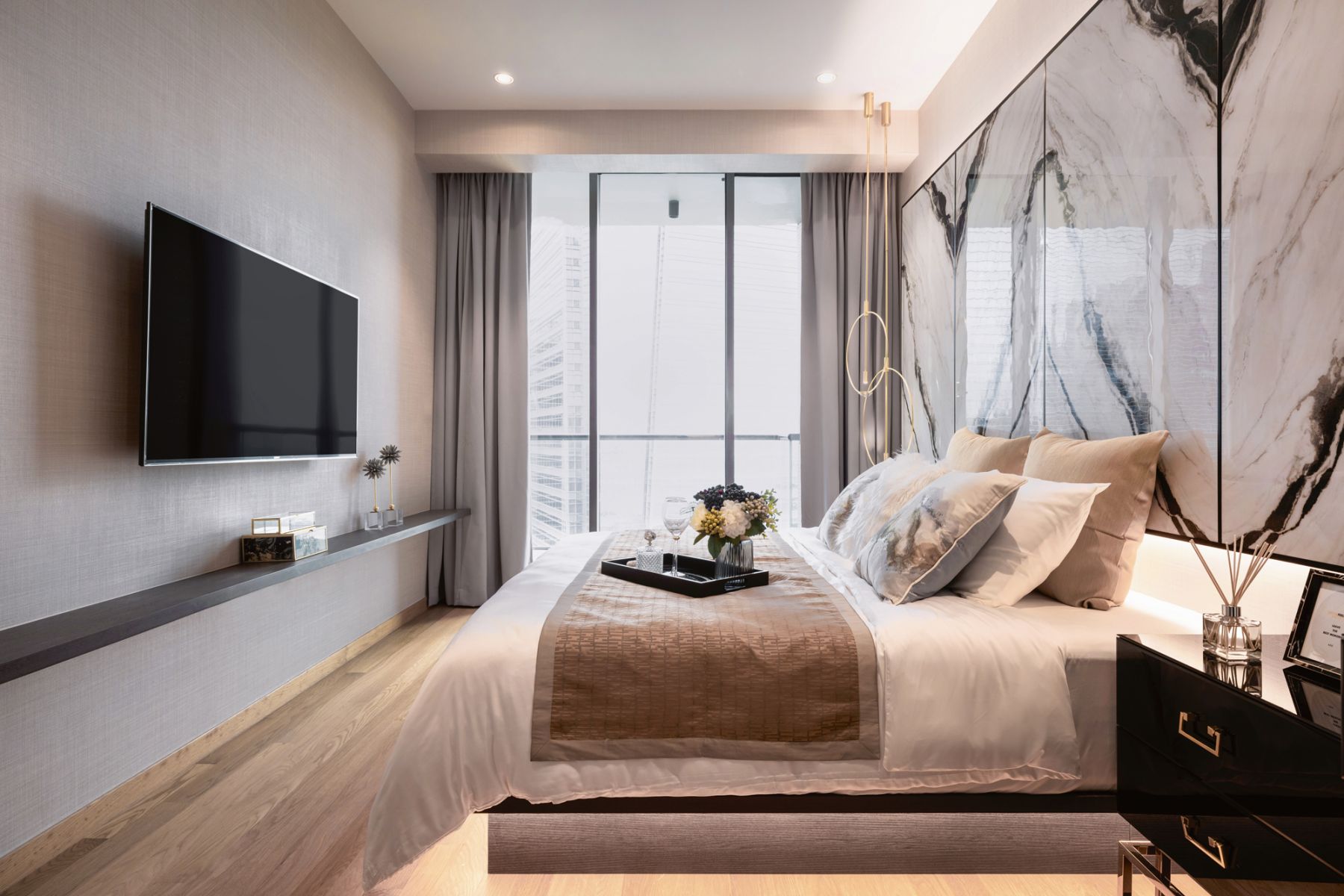 The floating bed creates a sense of lightness in the master suite, which also features a book-matched marble headboard