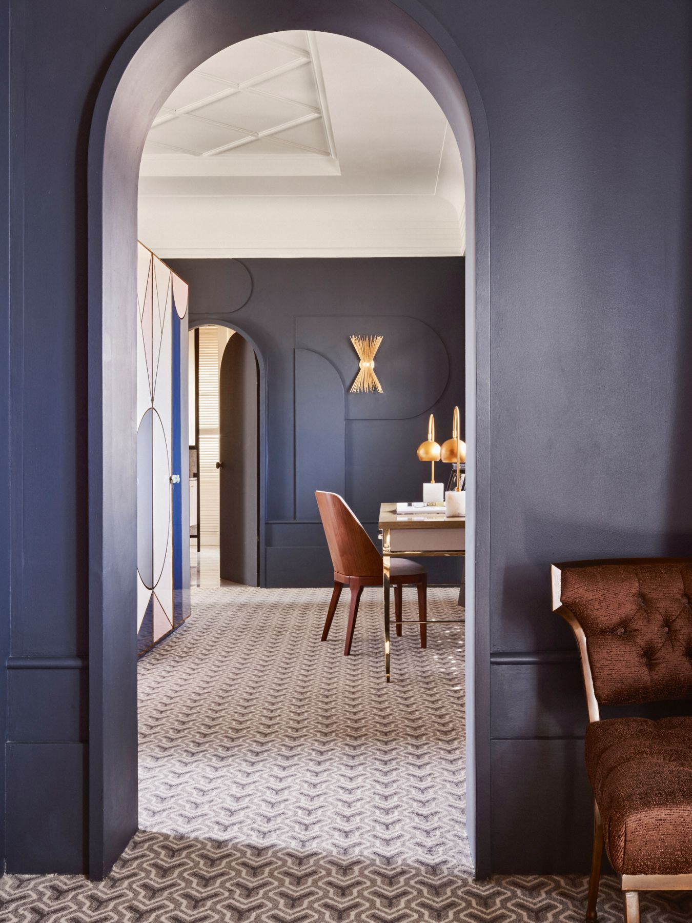 Navy blue walls create a serene mood in the master suite