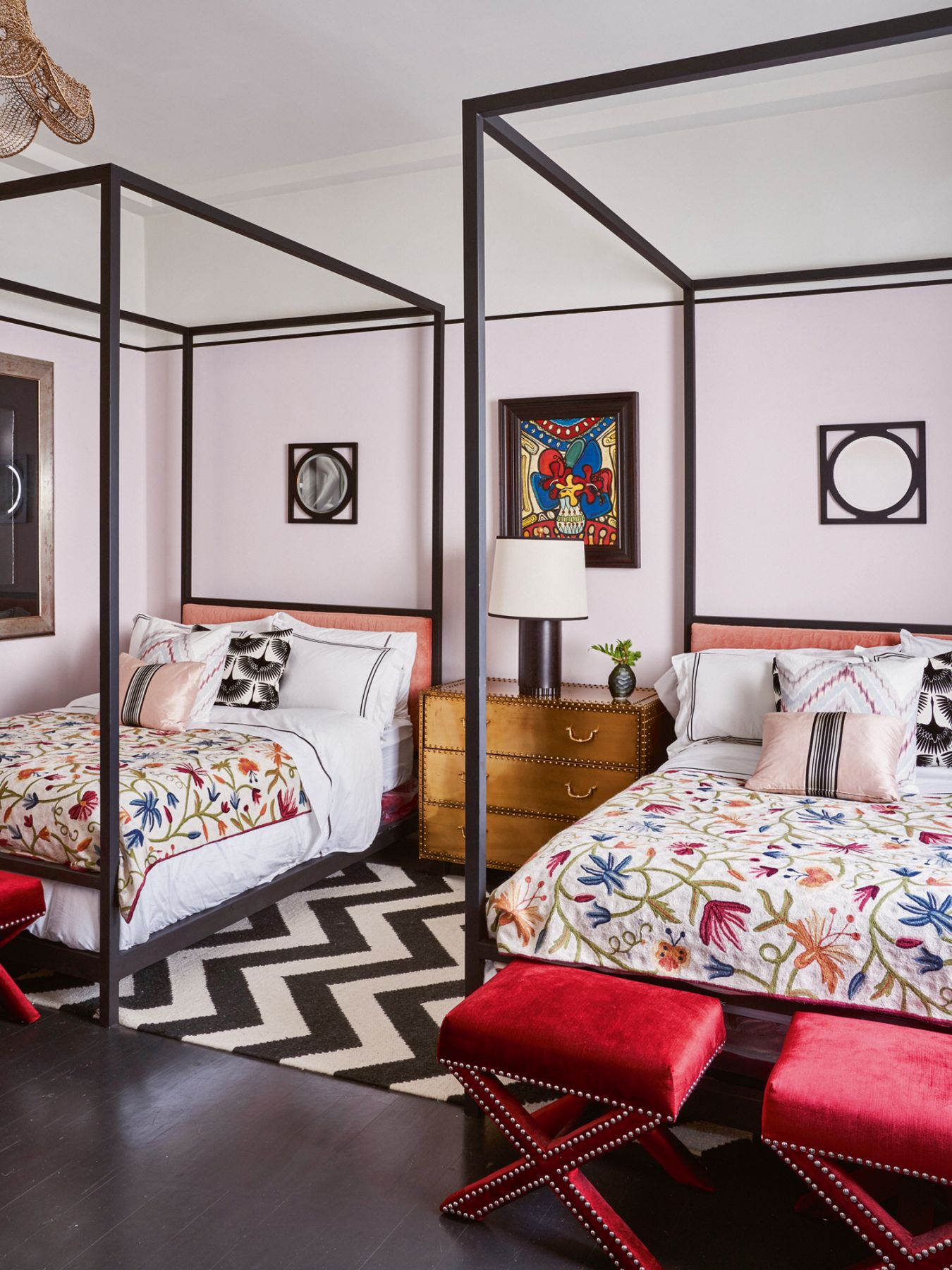 The house is full of unexpected combinations, like this pastel room with a zigzag rug and floral bedlinen