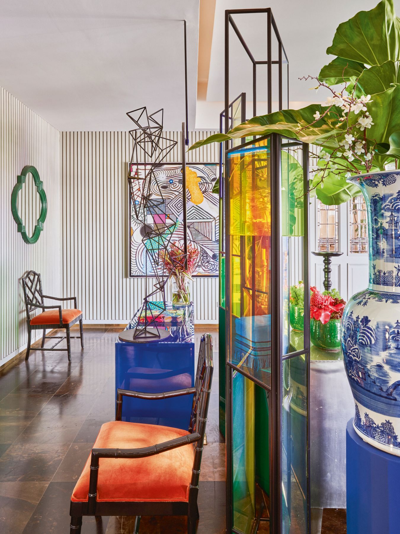 A custom steel-and-glass screen separates the hall from the dining room