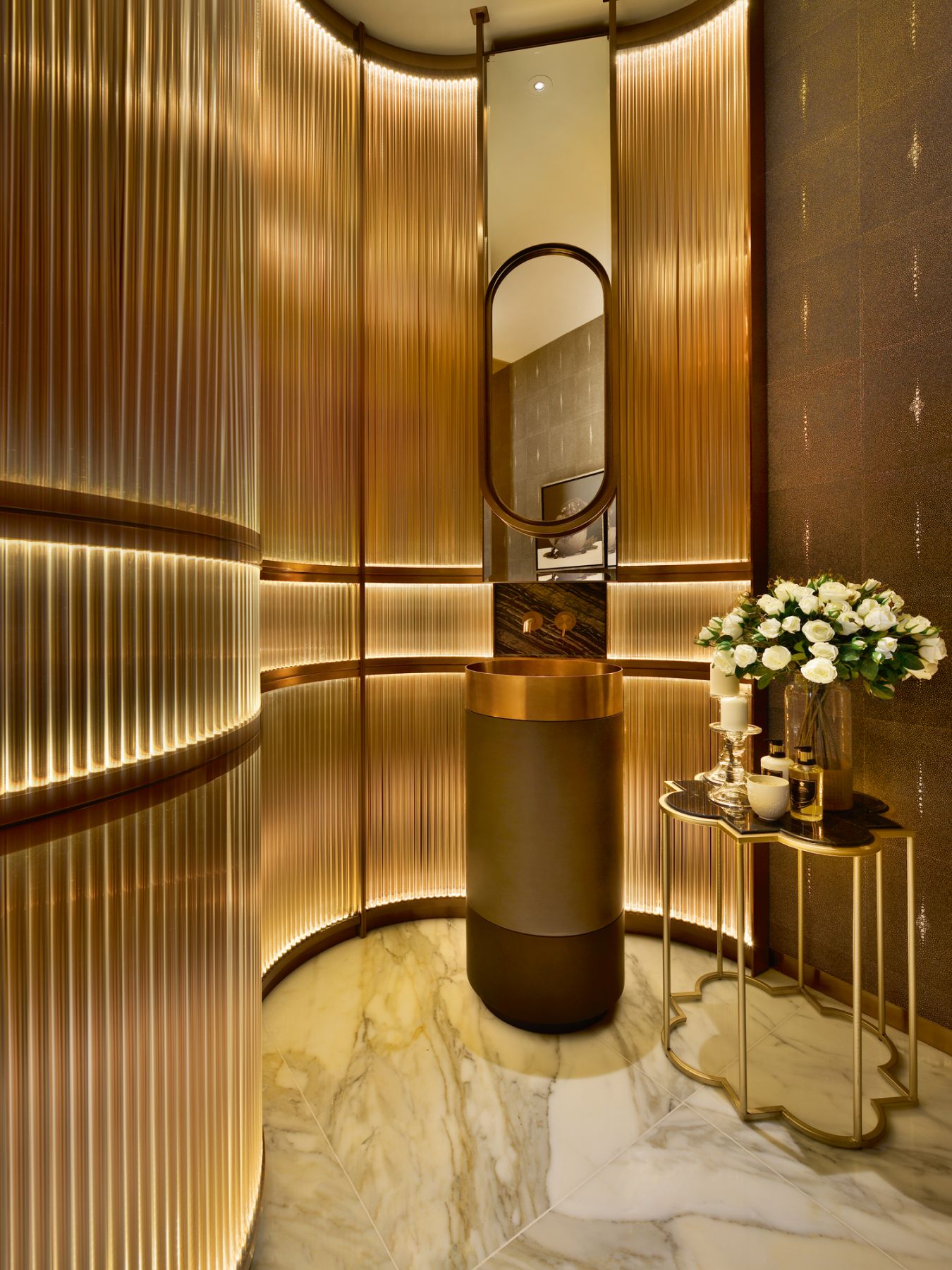The curved walls in this powder room make a sculptural statement in a compact space