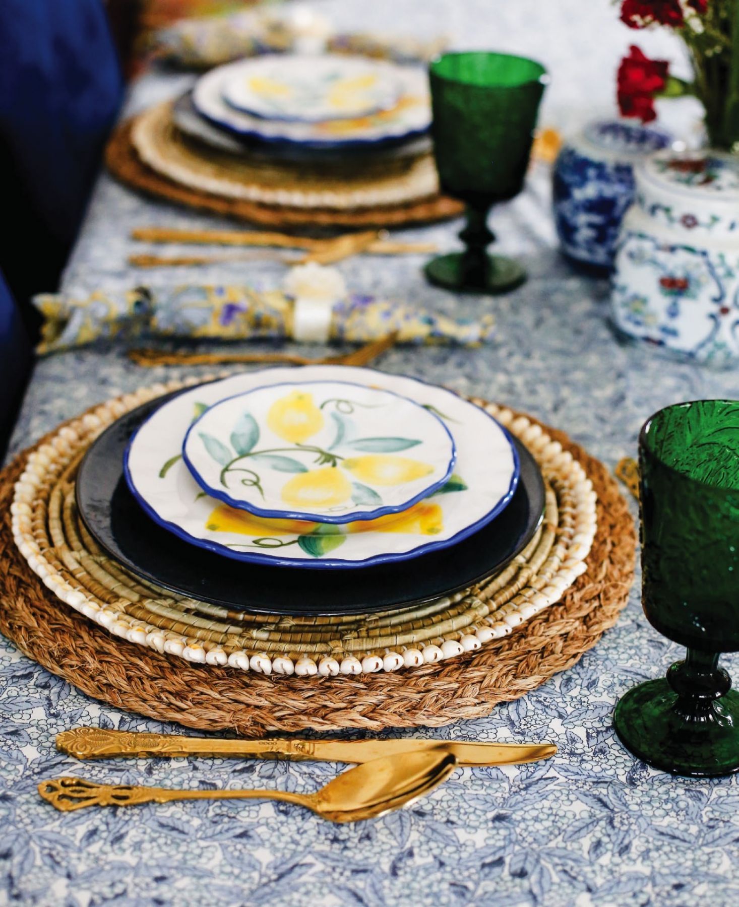 Vivid colours of green, blue and yellow strike a contrast with tropical placemats and vintage-style gold cutlery