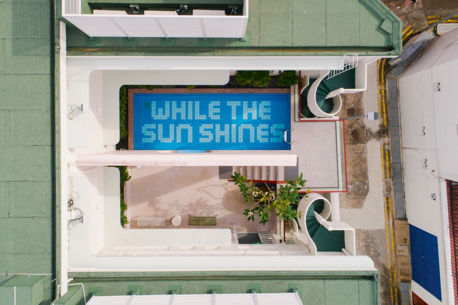 An aerial view of the pool area of The Great Madras boutique hotel, an adaptive reuse project designed by Farm that’s housed in a conserved building from the 1940s (Photography: Farm (The Great Madras)