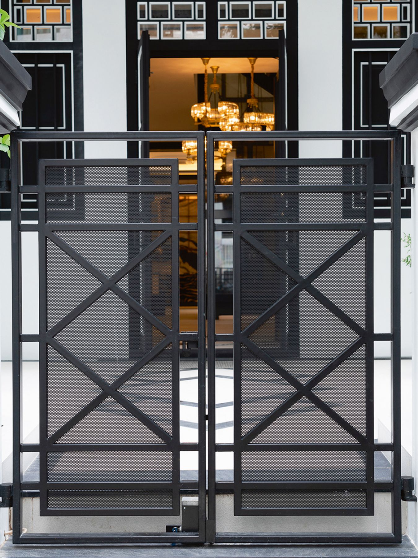 The geometric patterns on the gate reference the art deco influences of the historical building