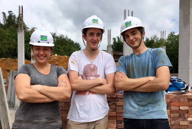 Josianne Robb with her sons volunteering with Habitat for Humanity