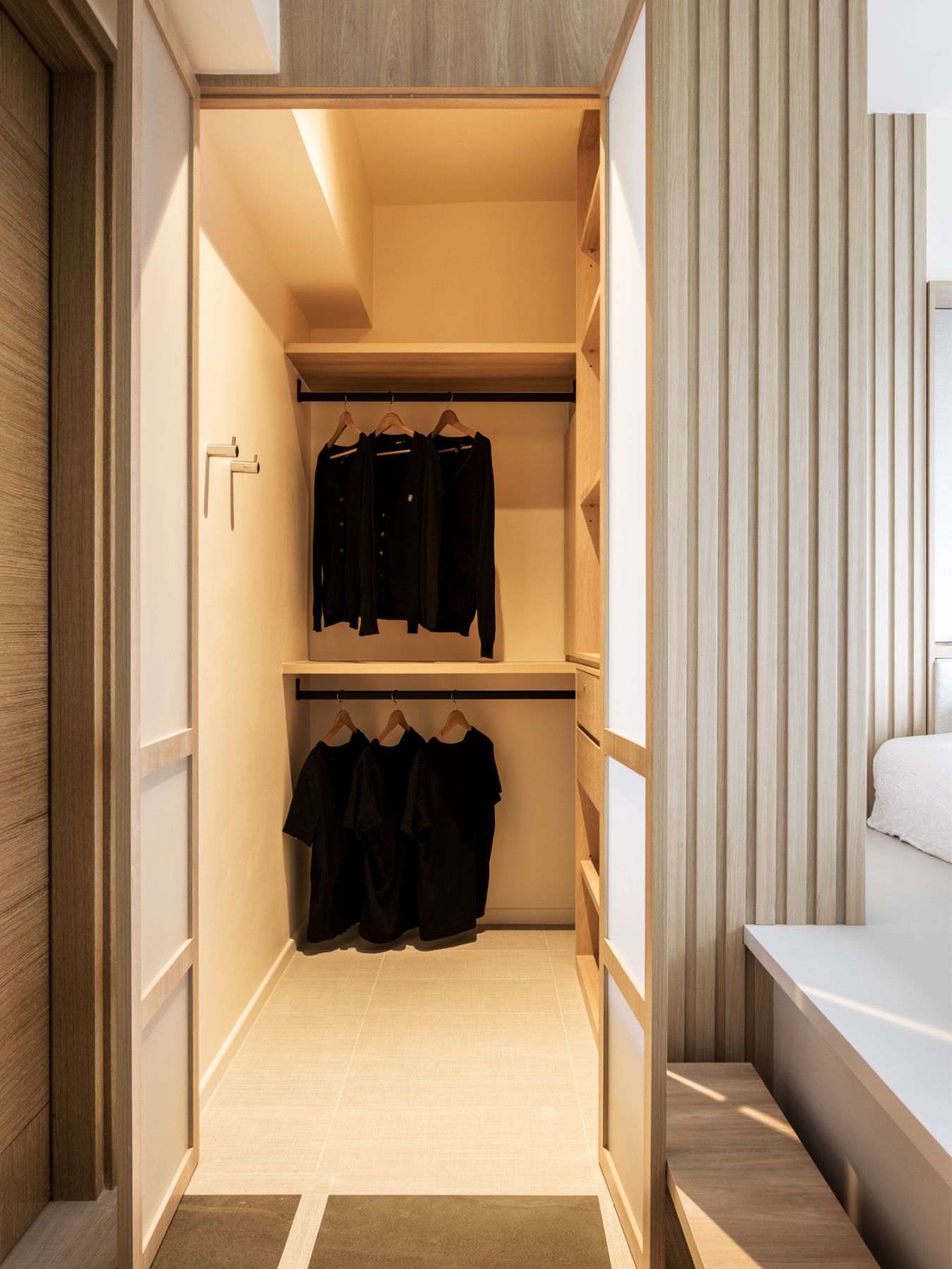 The walk-in closet hidden at the side of the room can be accessed via the Shoji-inspired doors