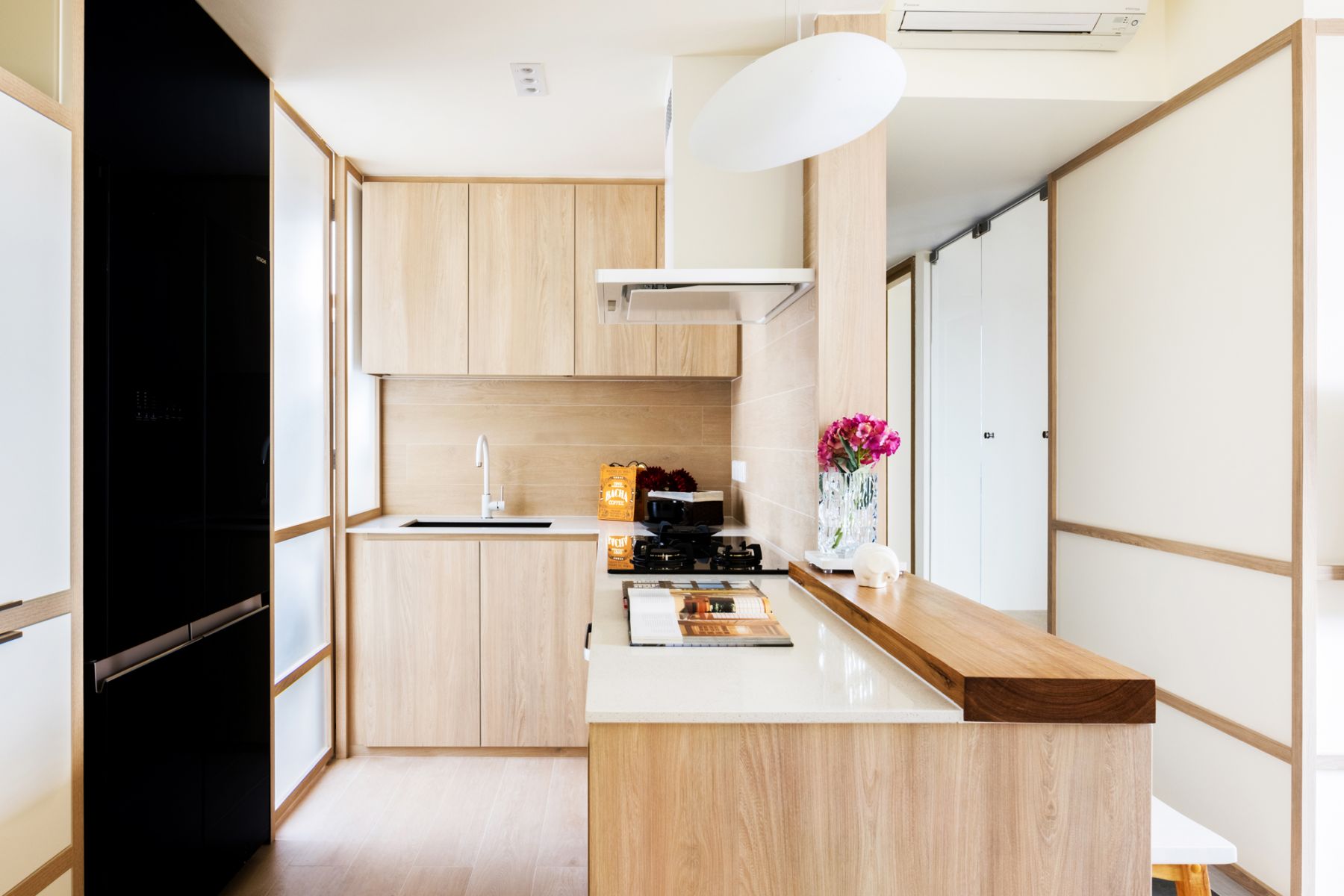 The chic kitchen is bright and cosy, courtesy of the open-space floor plan and Shoji-inspired doors that allow natural light to flow through