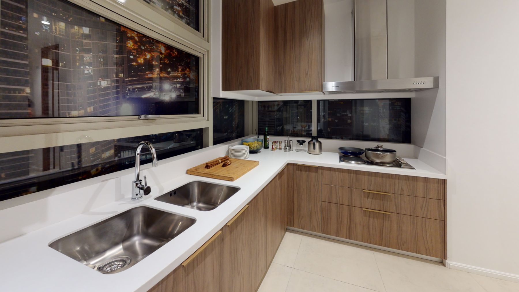 The Service Kitchen of 3 Bedroom with Den Units at the high zone feature cabinets with high-end finish and a high-end solid surface countertop.