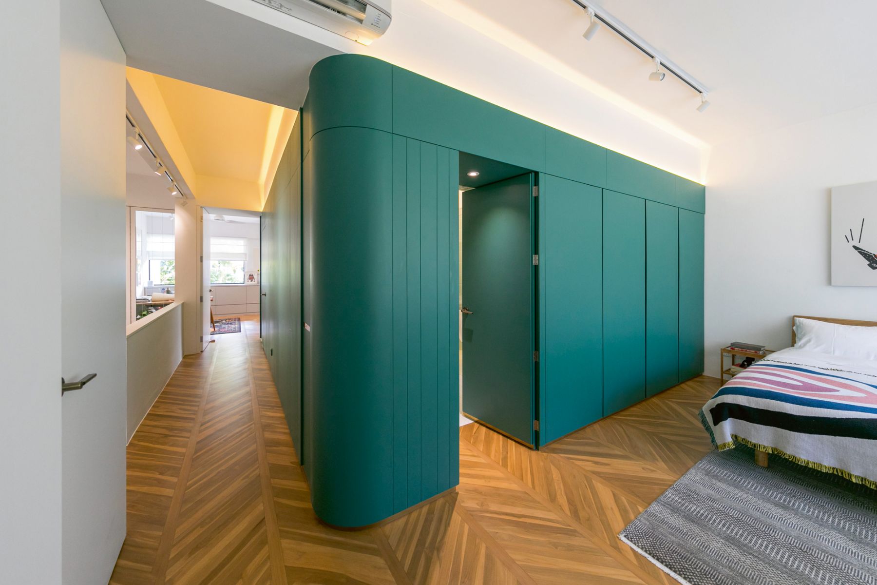 An ingenious structure wraps around the bathrooms, cabinetry, master suite and workshop areas