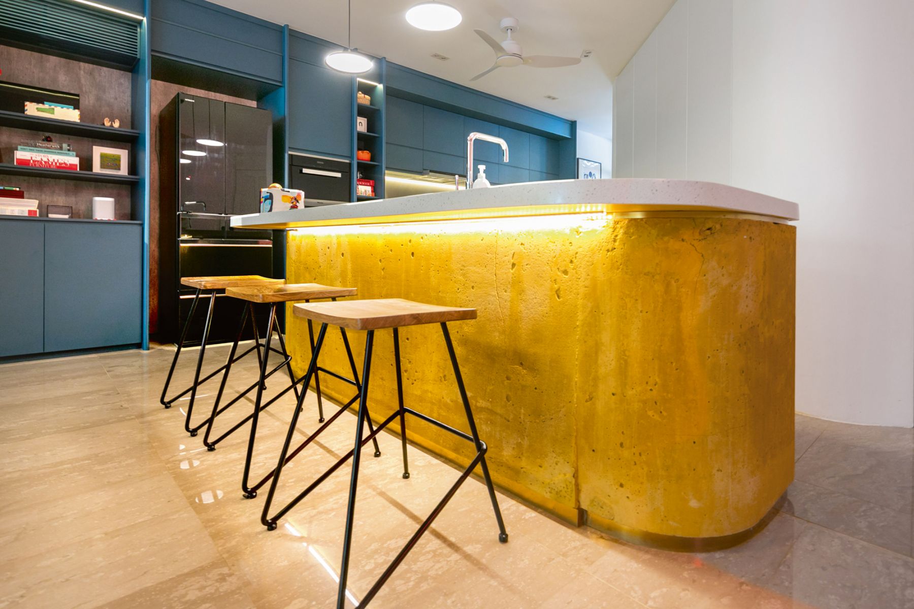 A yellow concrete kitchen counter is among the unexpected flourishes in this home