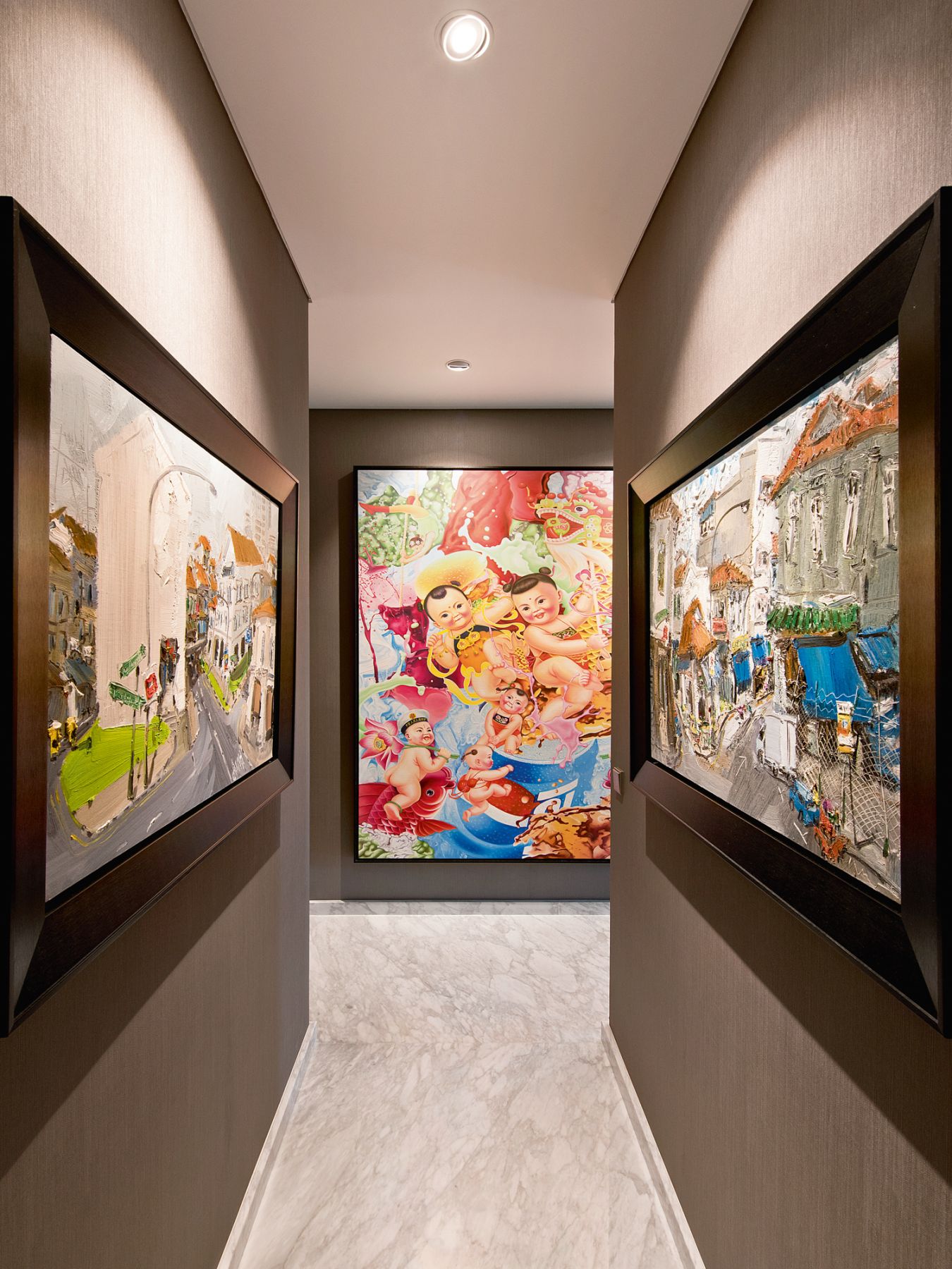 Colourful artworks add vibrance to the walls of this corridor