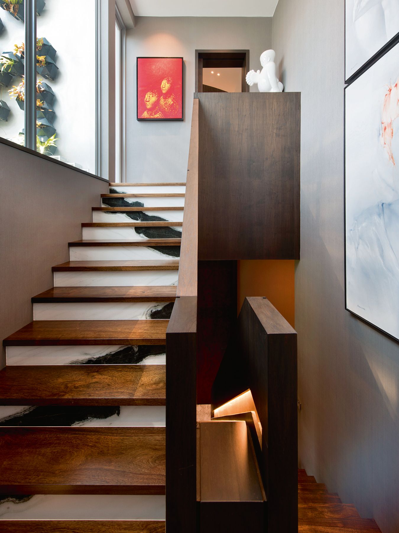 A striking red painting from Pan De Hai’s Corn series catches the eye at the staircase