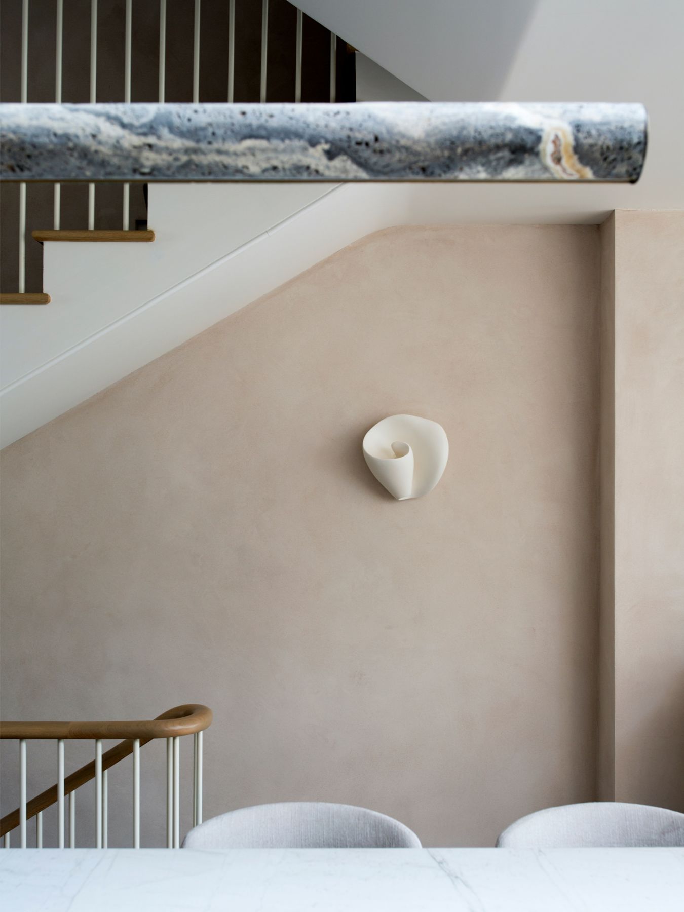 The walls of the abode are clad in natural clay, adding texture to the space