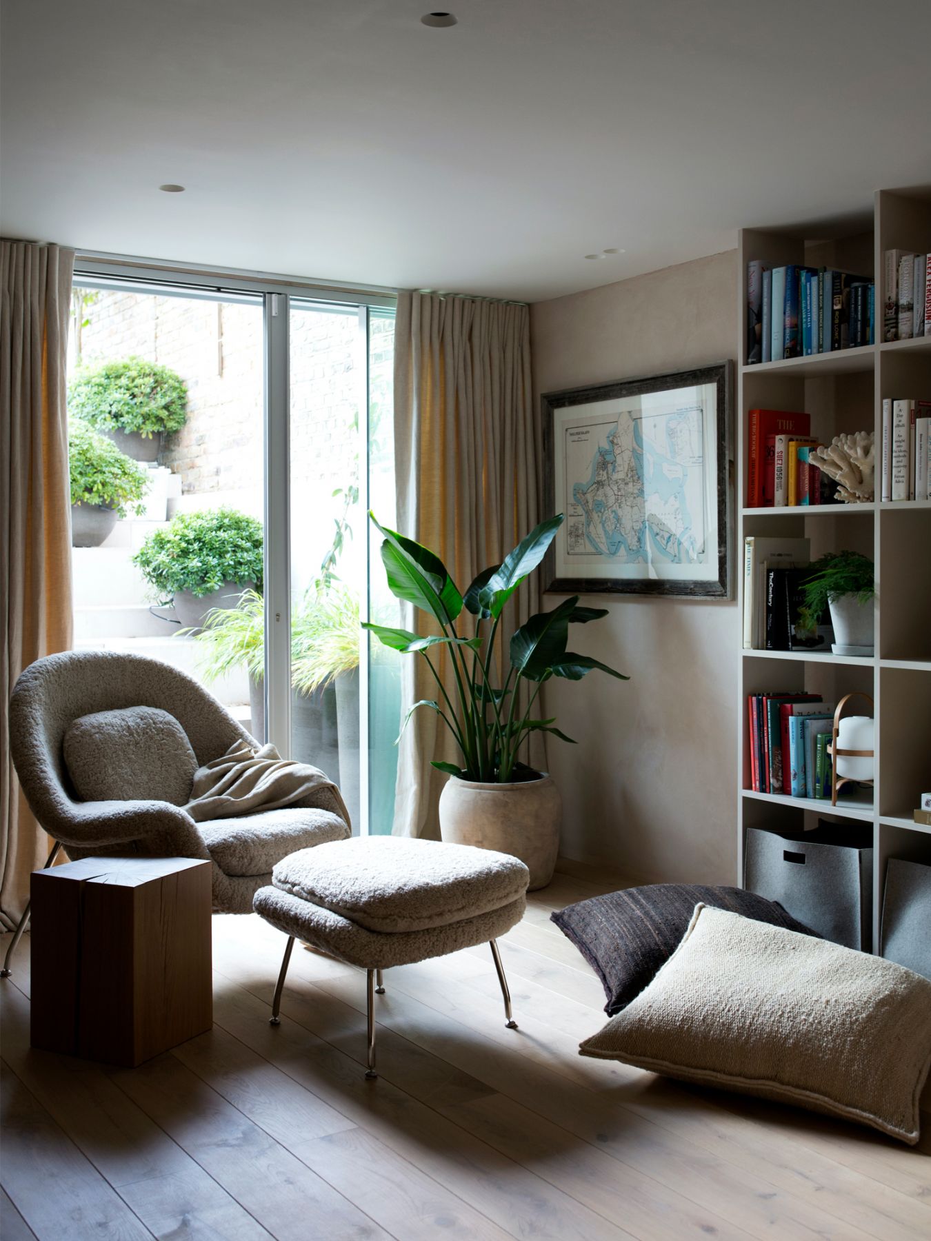 The children's playroom features a reading nook with a large shelving unit lining the wall