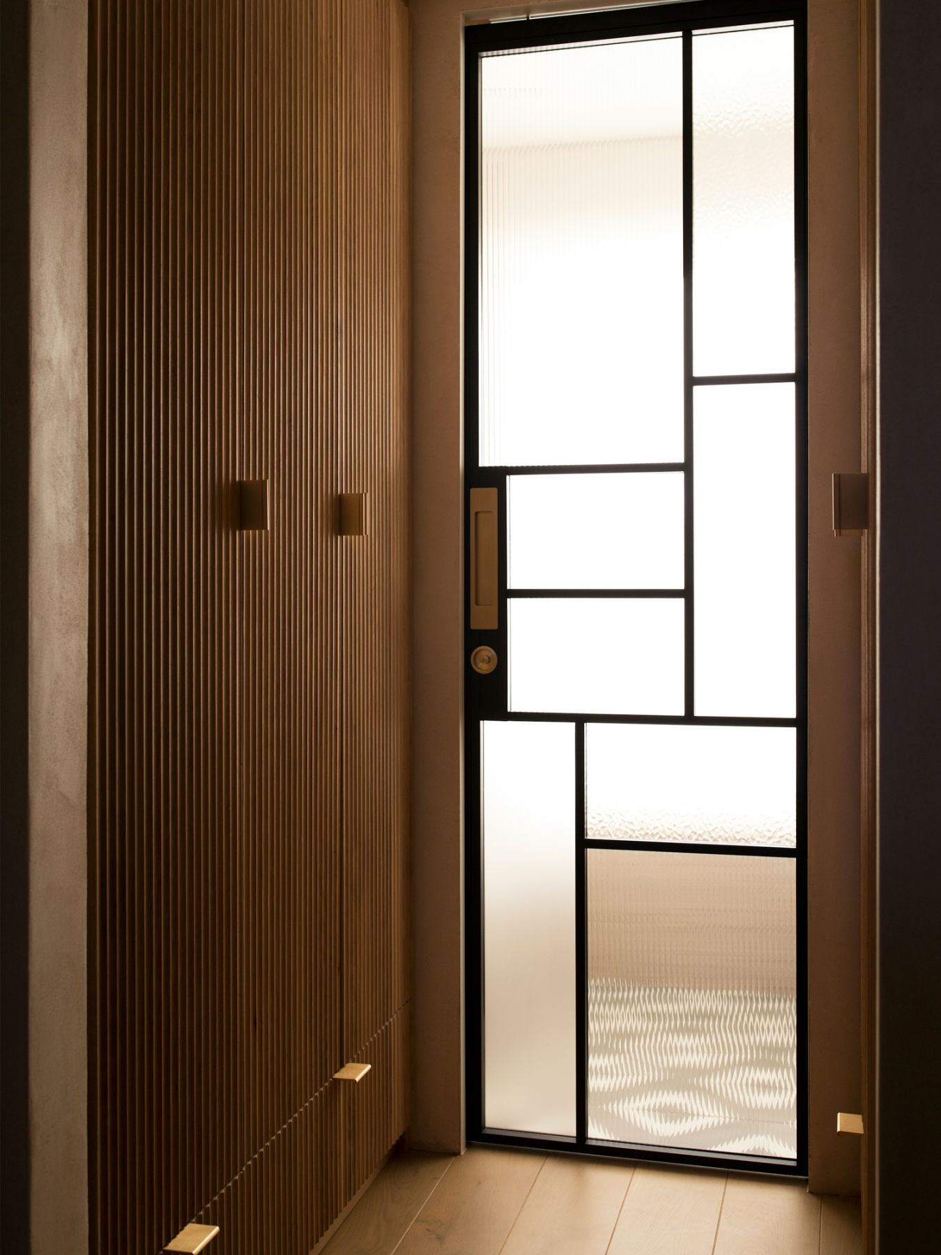 A mix of fluted timber and joinery adds warmth to the interiors